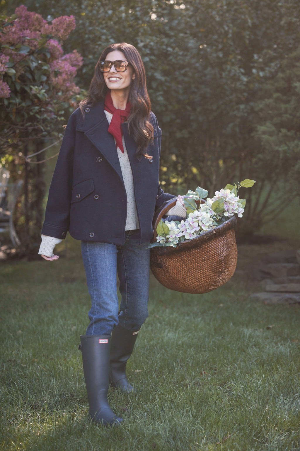 Navy double-breasted melton jacket with notch lapels and button closure, worn over red and white layered top.