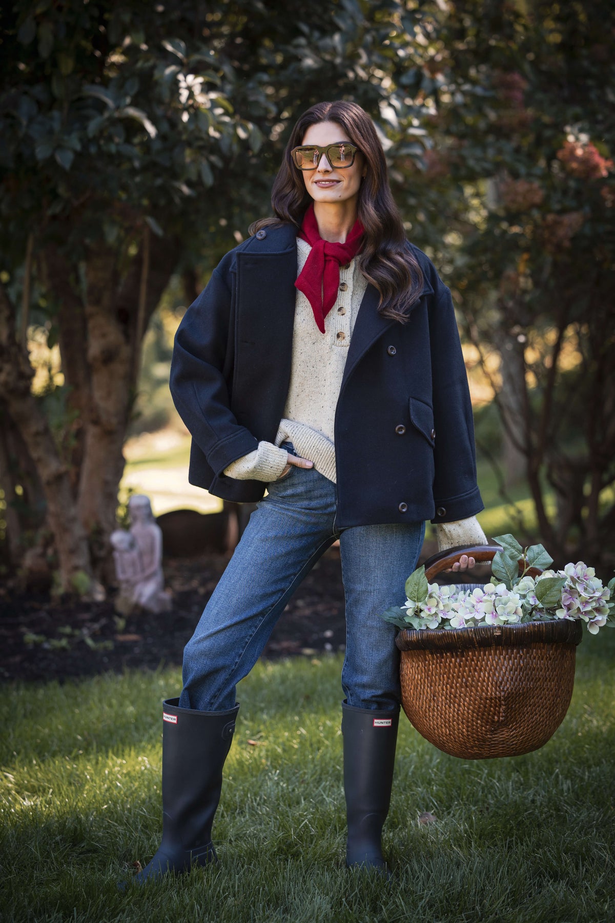 Heather gray henley sweater with long sleeves and button placket worn under navy blazer.