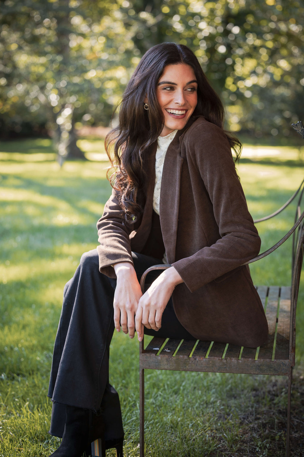 Brown corduroy blazer with notch lapels worn over white shirt and dark pants.