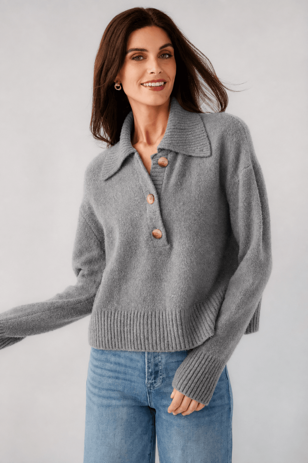 Grey knit polo sweater close-up, turn-down collar with buttons, long sleeves, ribbed hem