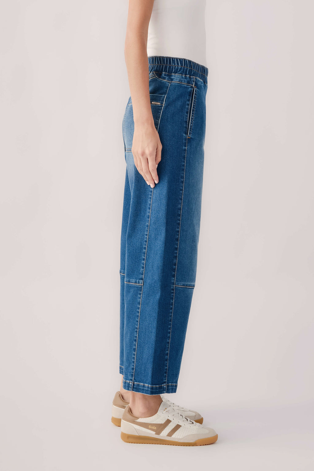 Blue pull-on barrel jeans with stitched seams and full-length wide legs