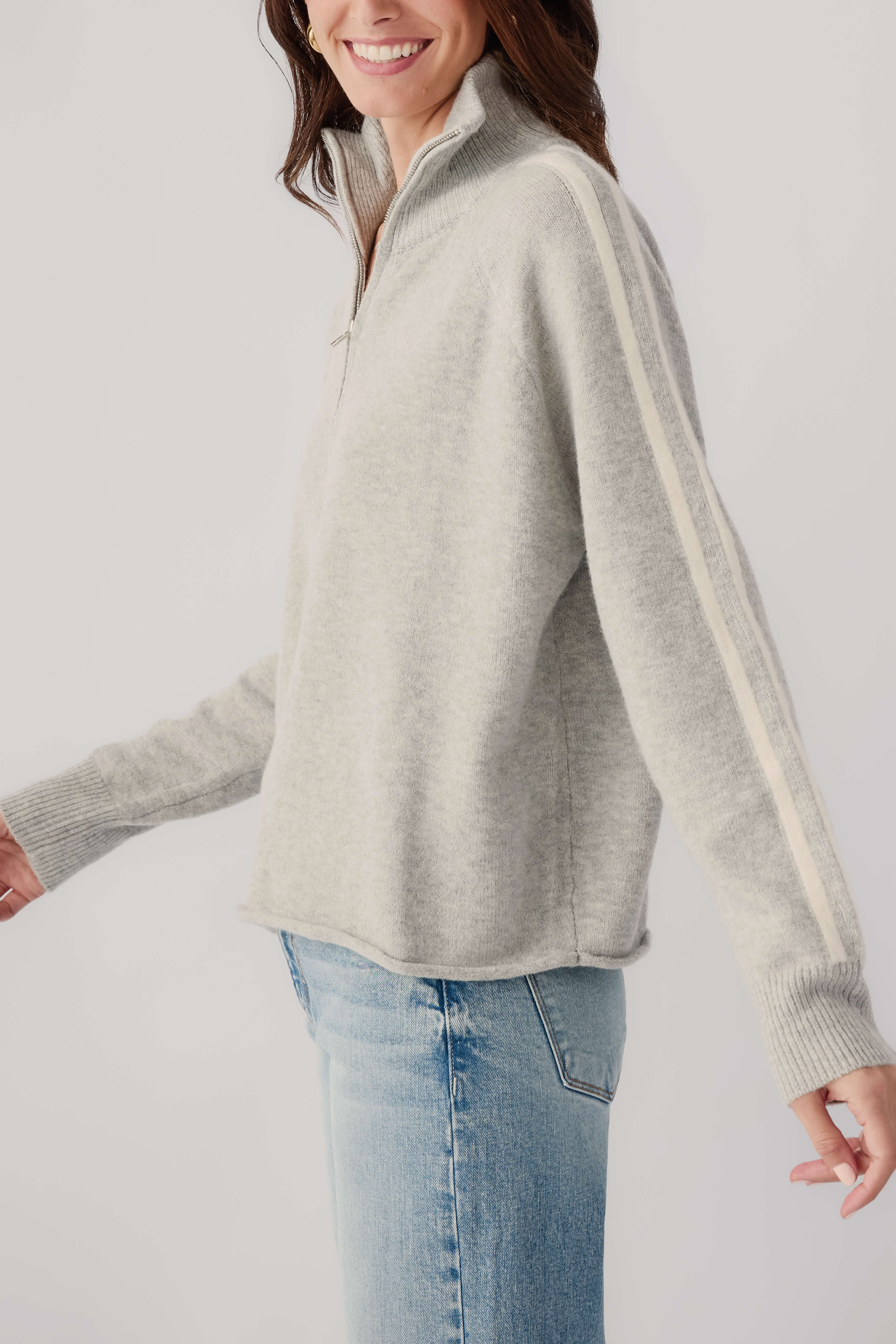 Heather grey 1/2-zip knit sweater with cream stripe detail along sleeve and hem