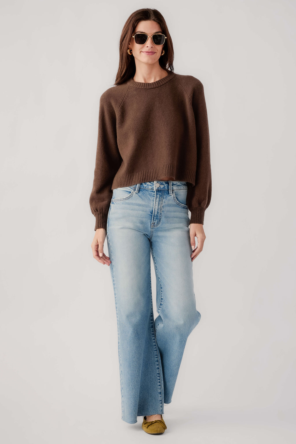 Dark brown crewneck knit sweater with ribbed cuffs and hem, front view