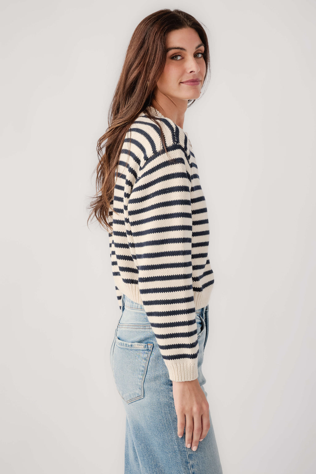 Striped button-front cardigan in black-and-white knit, side view with ribbed hem