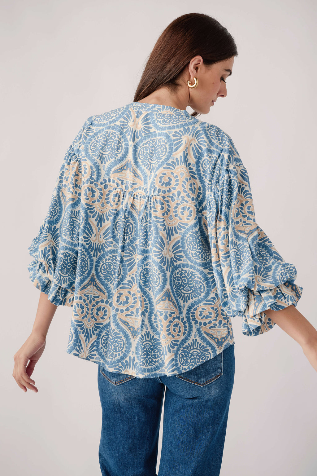 Blue damask print balloon-sleeve button-up top, back view with tiered sleeve cuffs