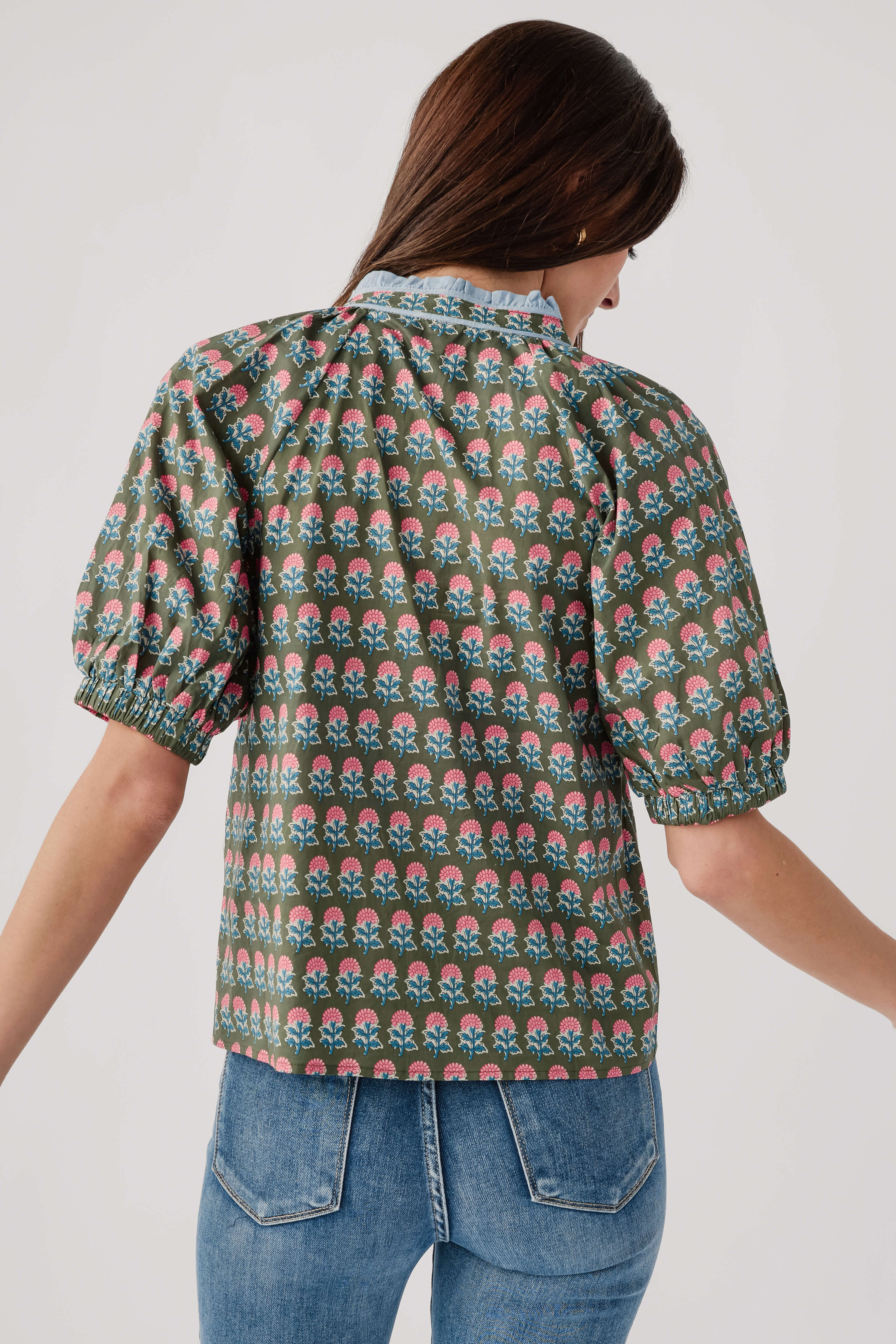 Back of green block-print top with puff sleeves and gathered yoke