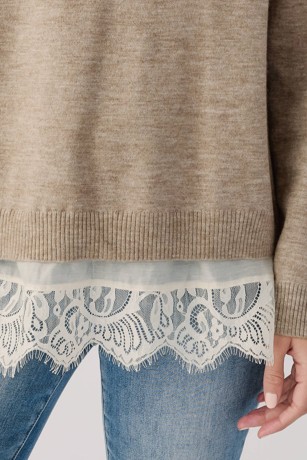 Heather mocha cream sweater hem with ribbed band and light lace trim over denim