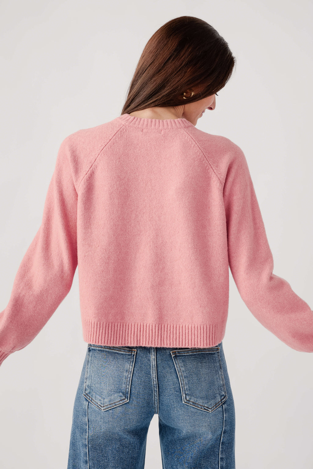 Pink crewneck knit sweater, back view with ribbed hem and cuffs