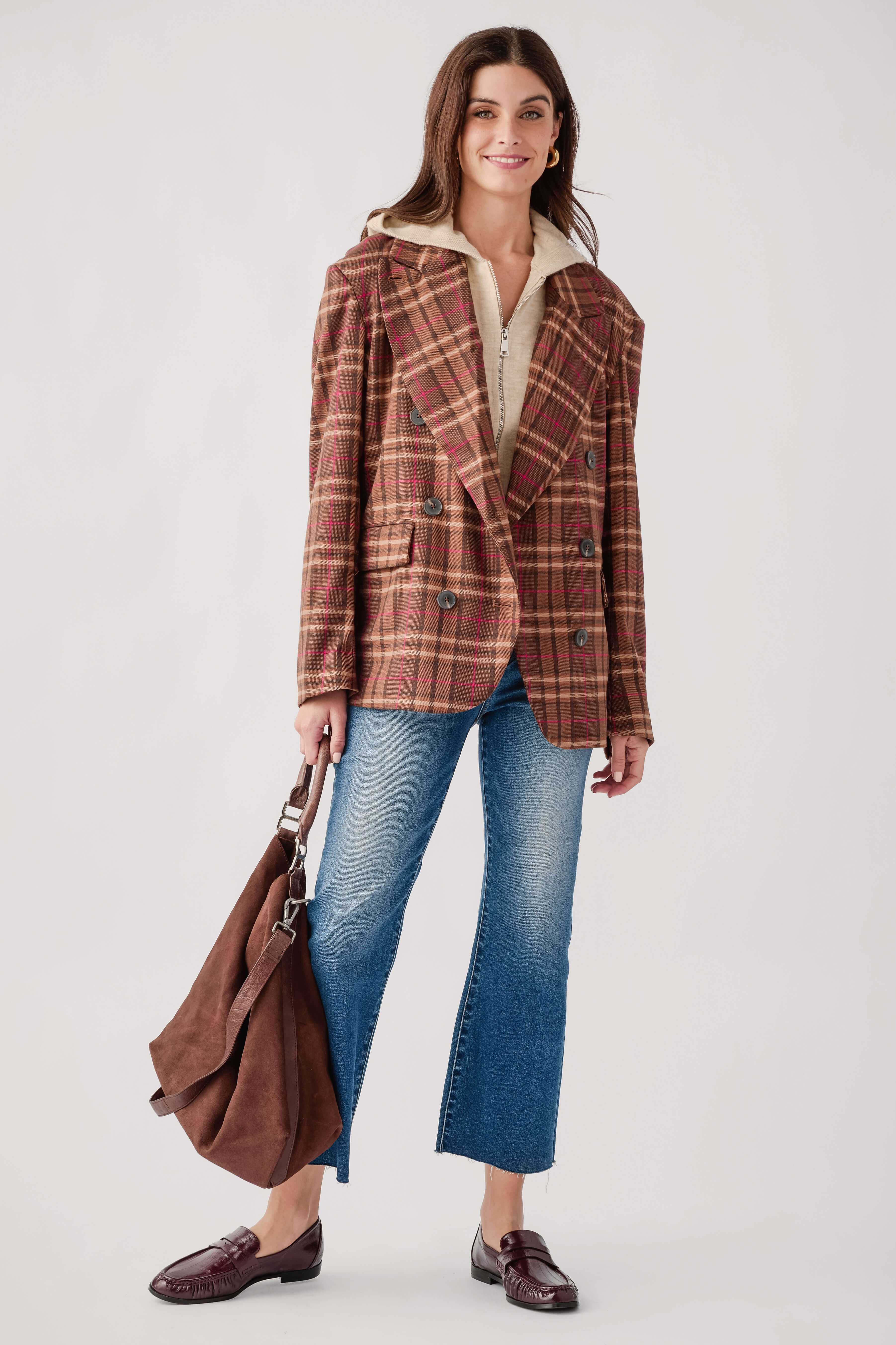 Oatmeal hooded sleeveless zip-up vest layered under plaid jacket, full-zip front