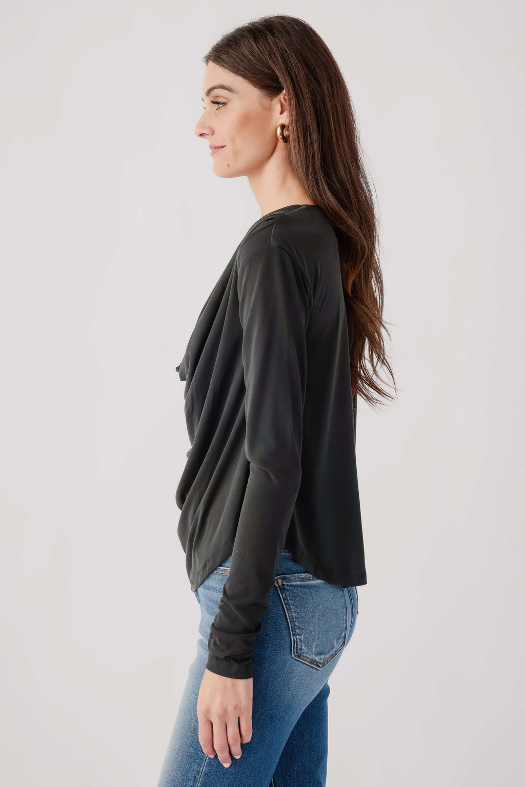 Black draped long-sleeve top, side view with relaxed fit