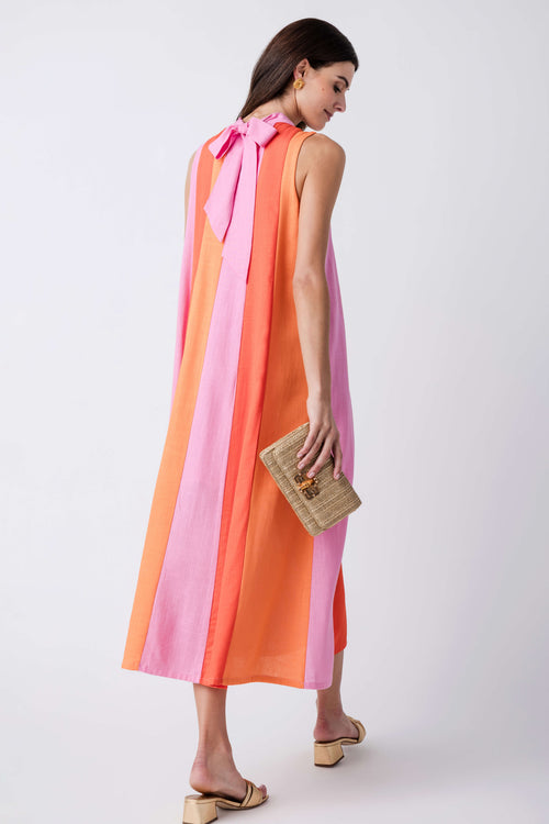 Back of sleeveless colorblock midi dress with pink bow tie and vertical stripe panels.