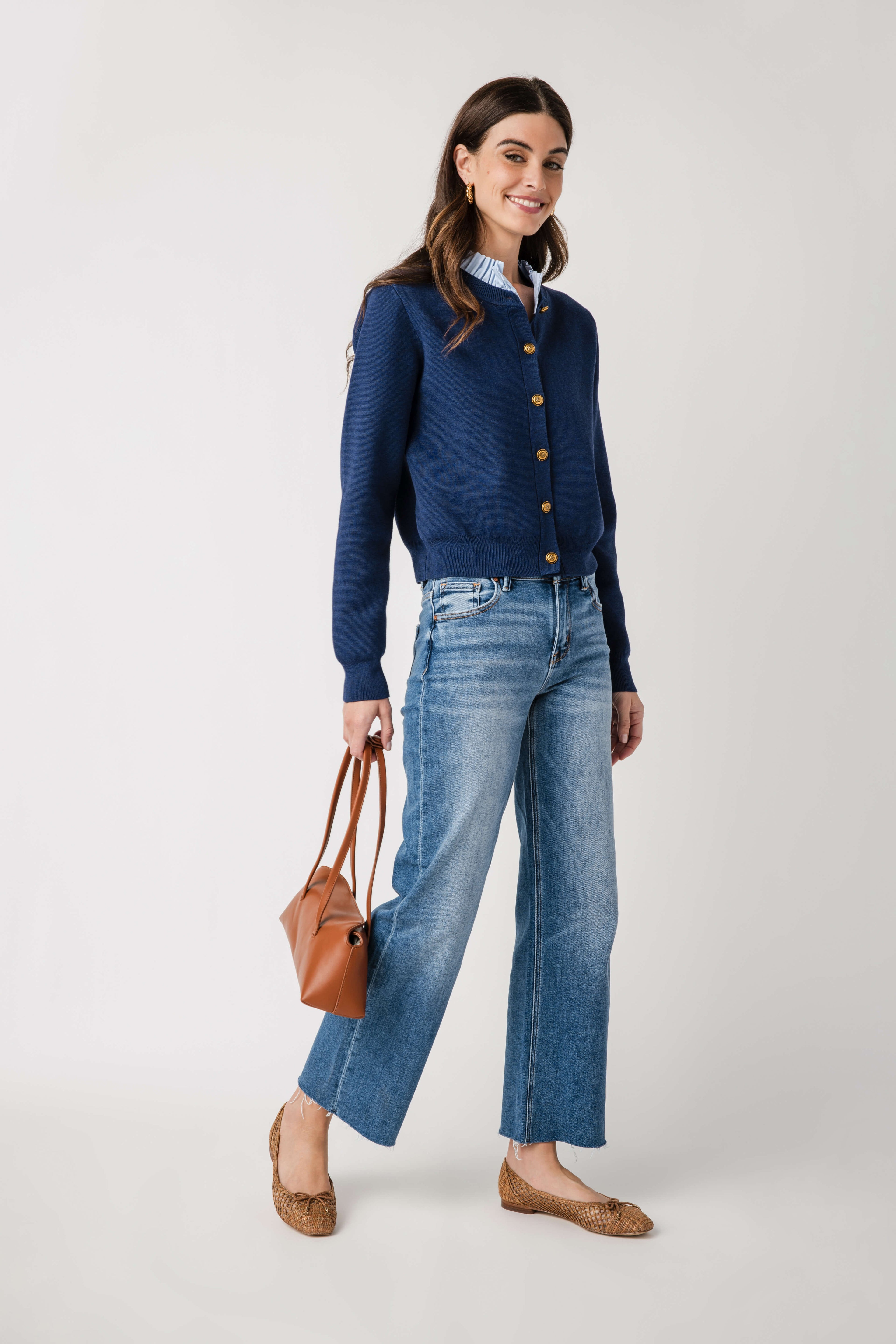 Navy ruffle-collar cardigan with button-front, long sleeves, ribbed cuffs