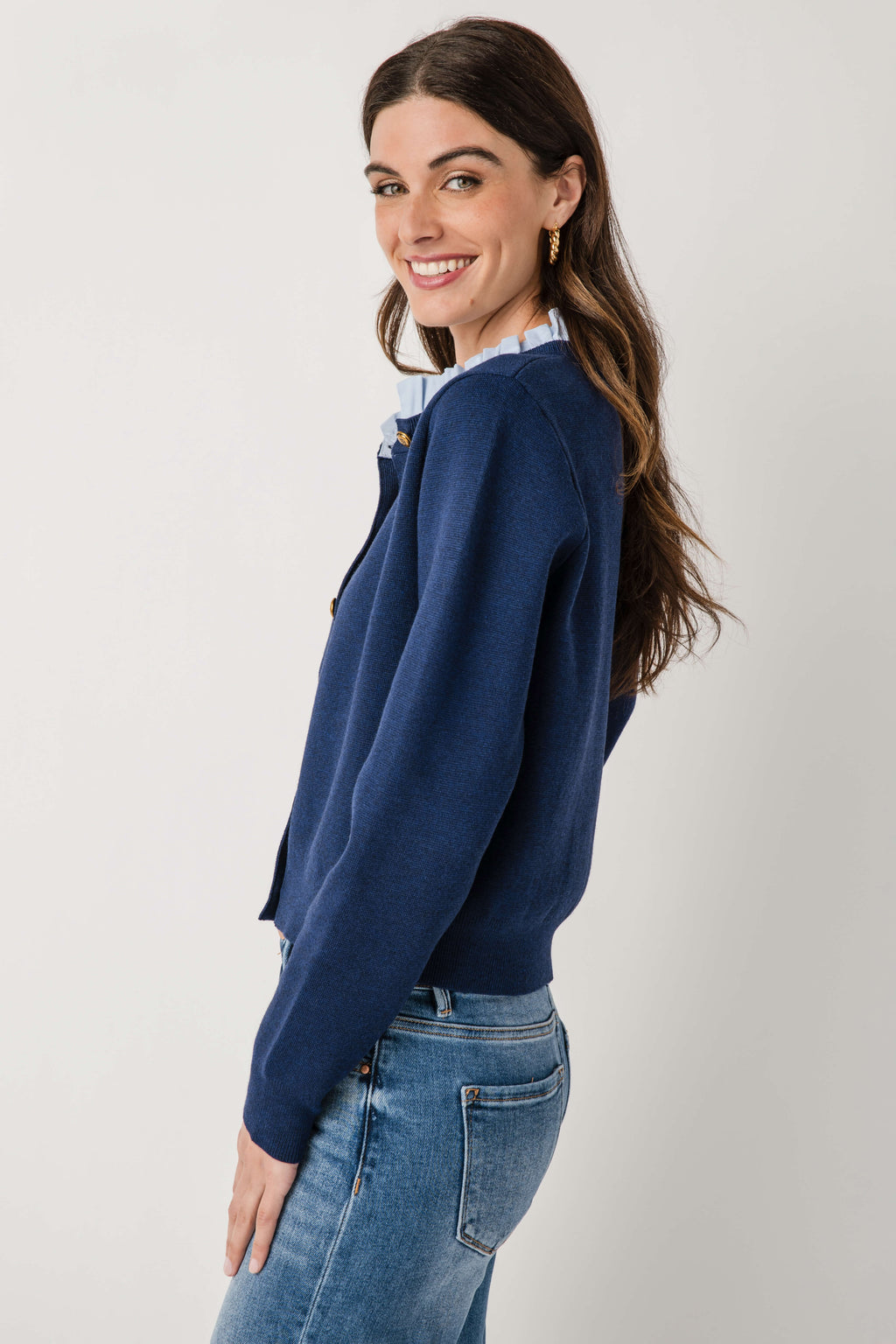 Navy ruffle-collar cardigan with ruffled neck and button-front, long sleeves