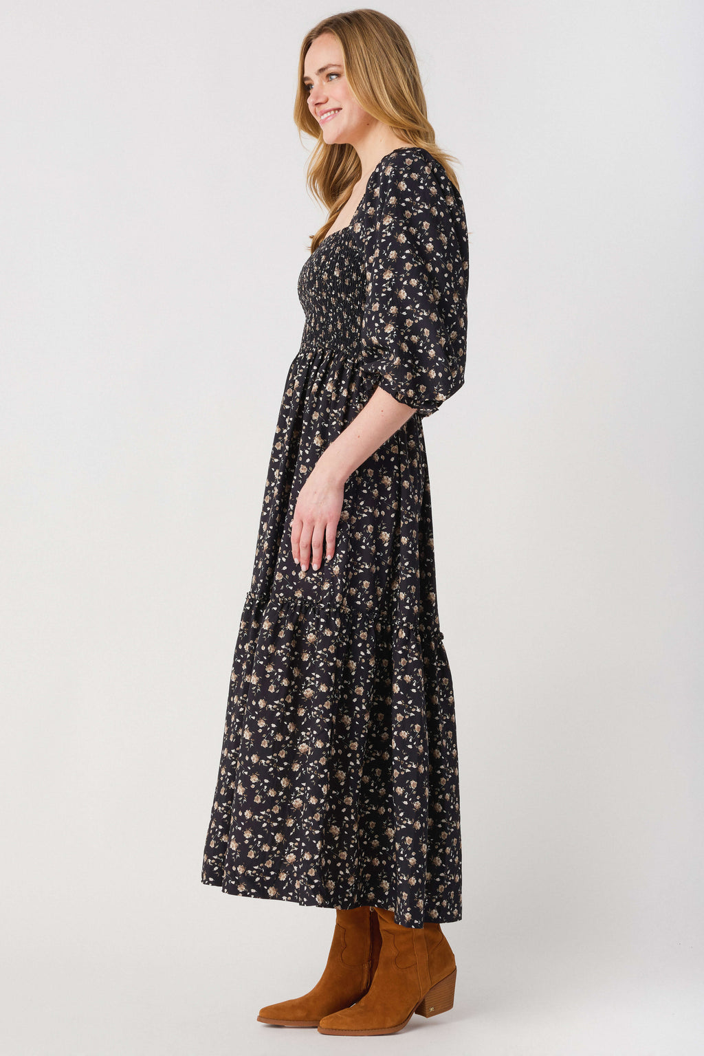 Black floral midi dress shown from side, square neckline and 3/4 puff sleeves