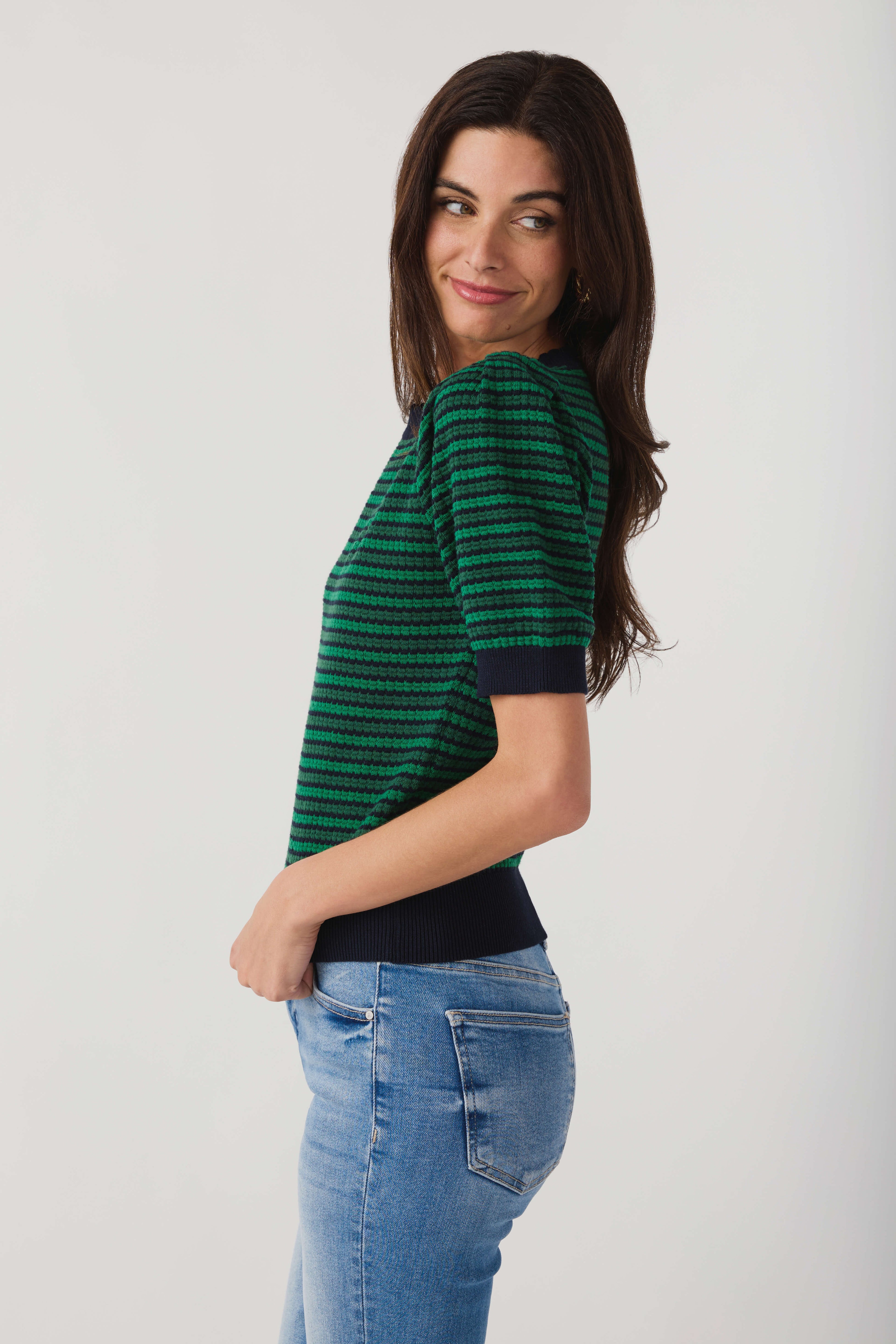 Side view of green and navy striped crochet top with ribbed hem and cuffs