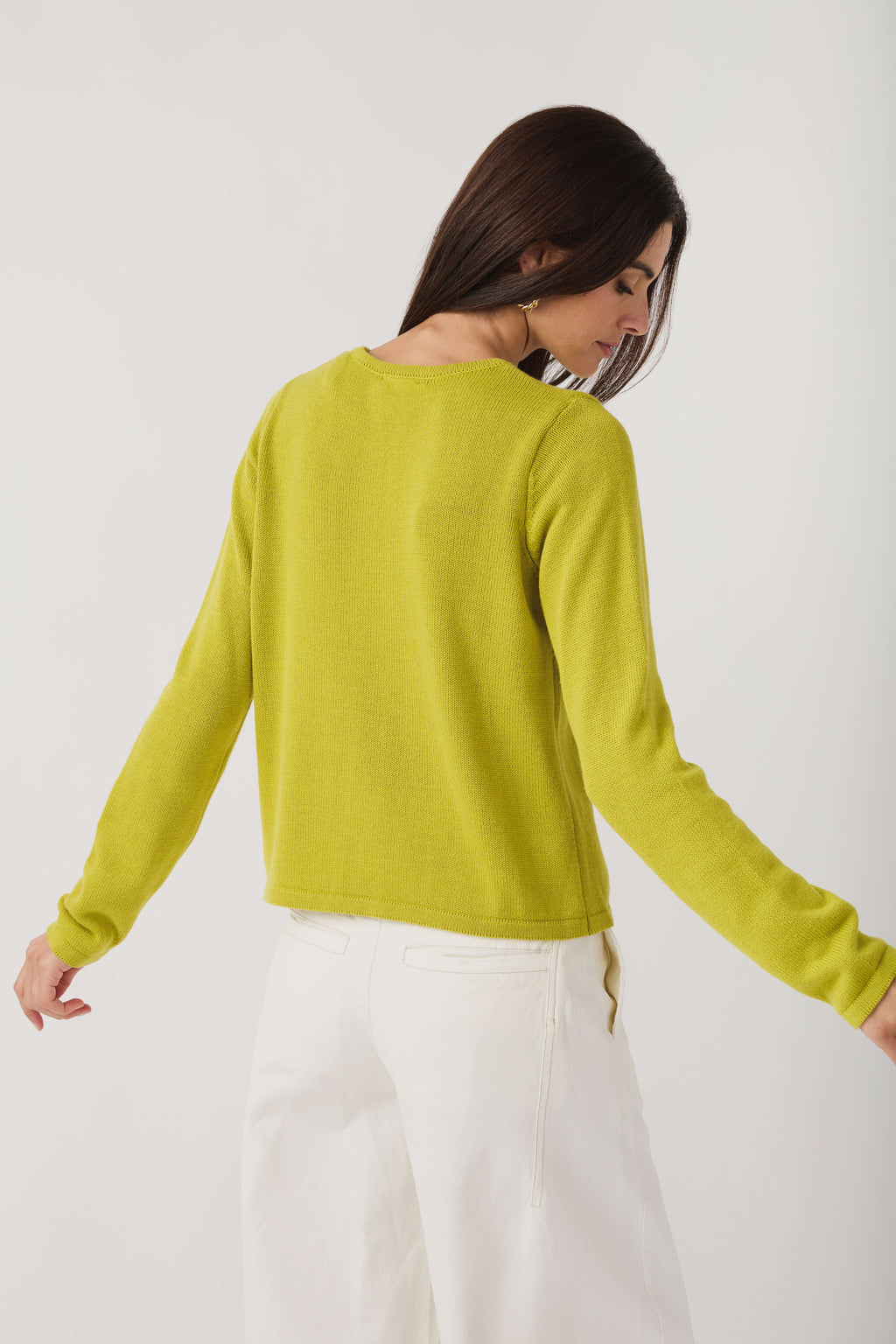 Back view of lime knit crewneck sweater with long sleeves and ribbed hem