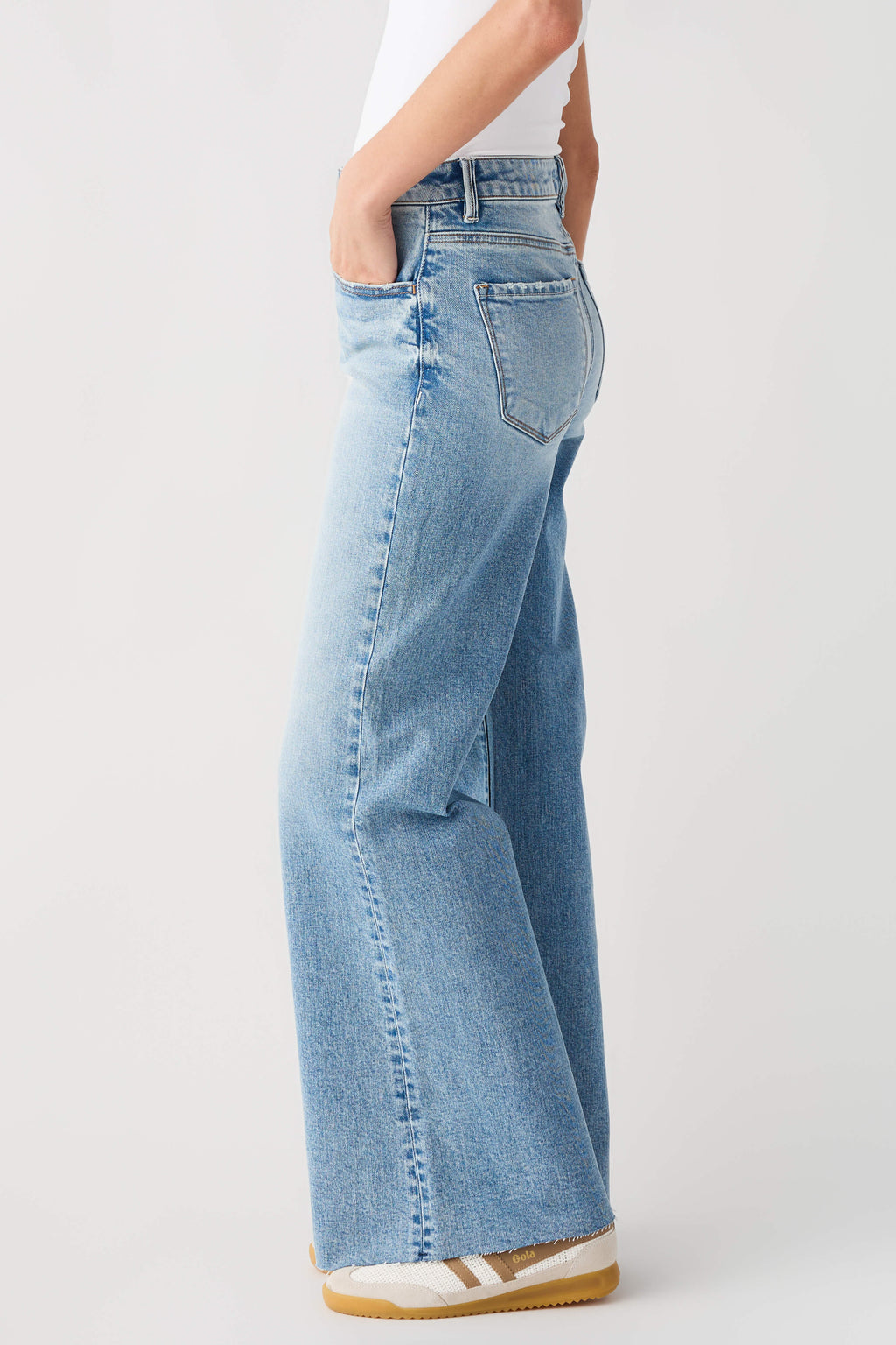 Light blue high-rise wide-leg jeans, side view with patch pocket and seam details