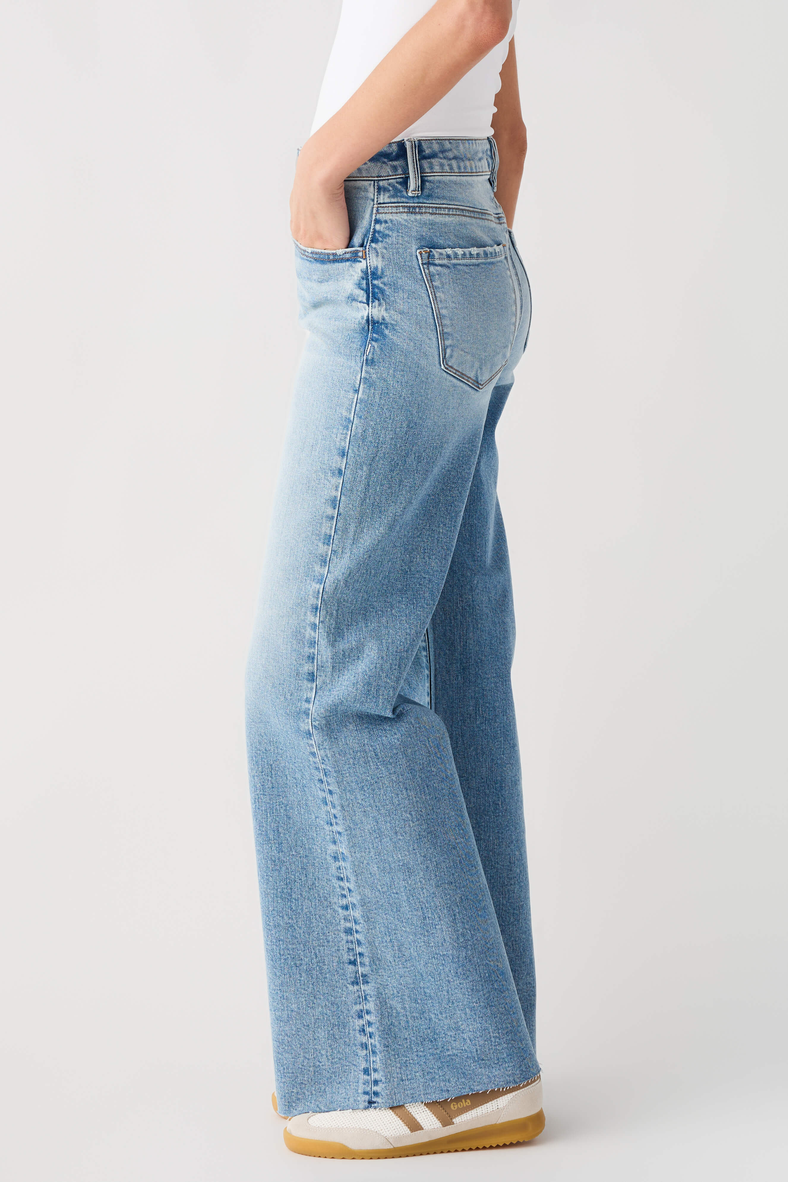 Light blue high-rise wide-leg jeans, side view with patch pocket and seam details