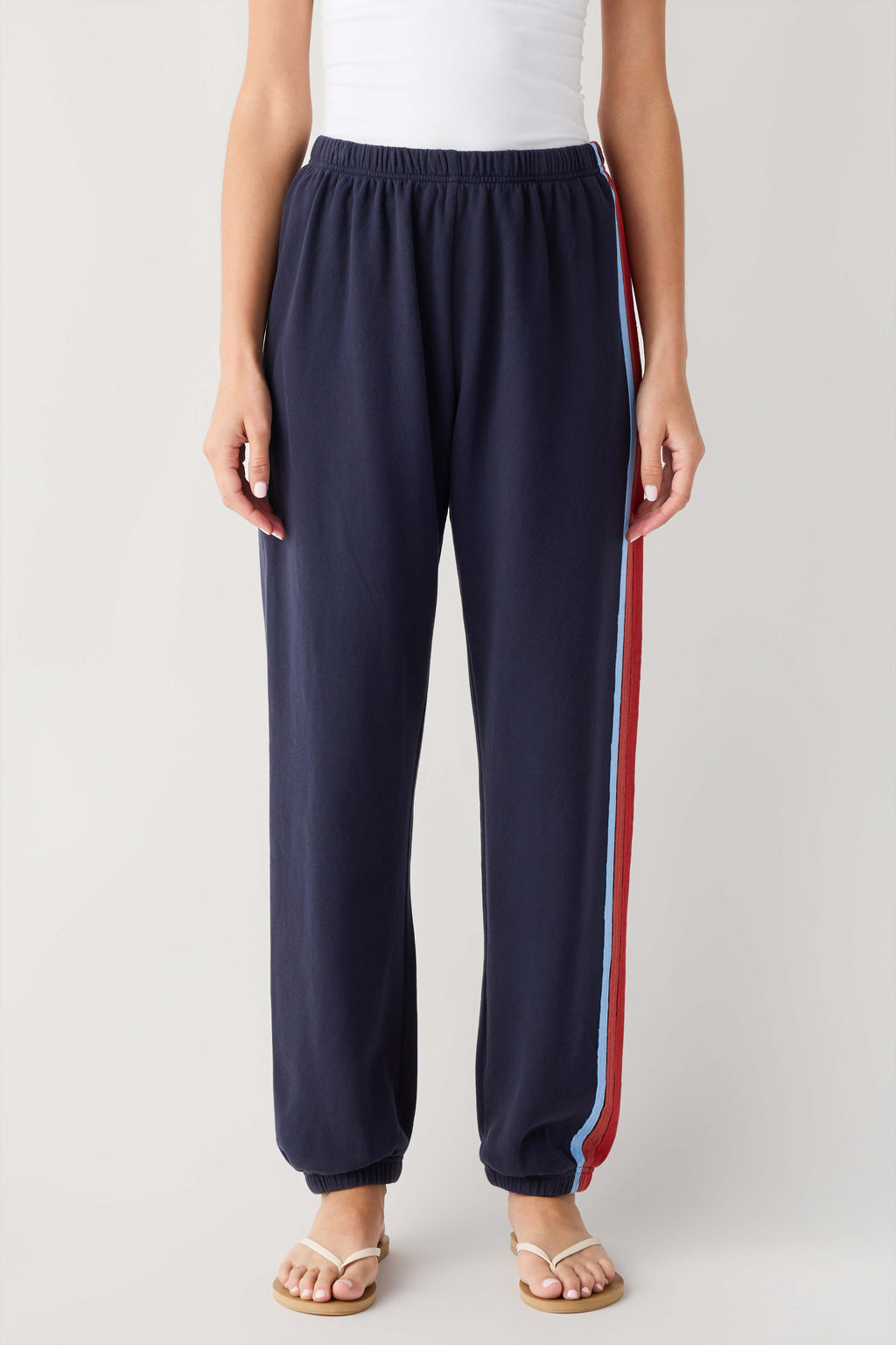 Navy jogger pants with wide red and blue side stripe and elastic waist