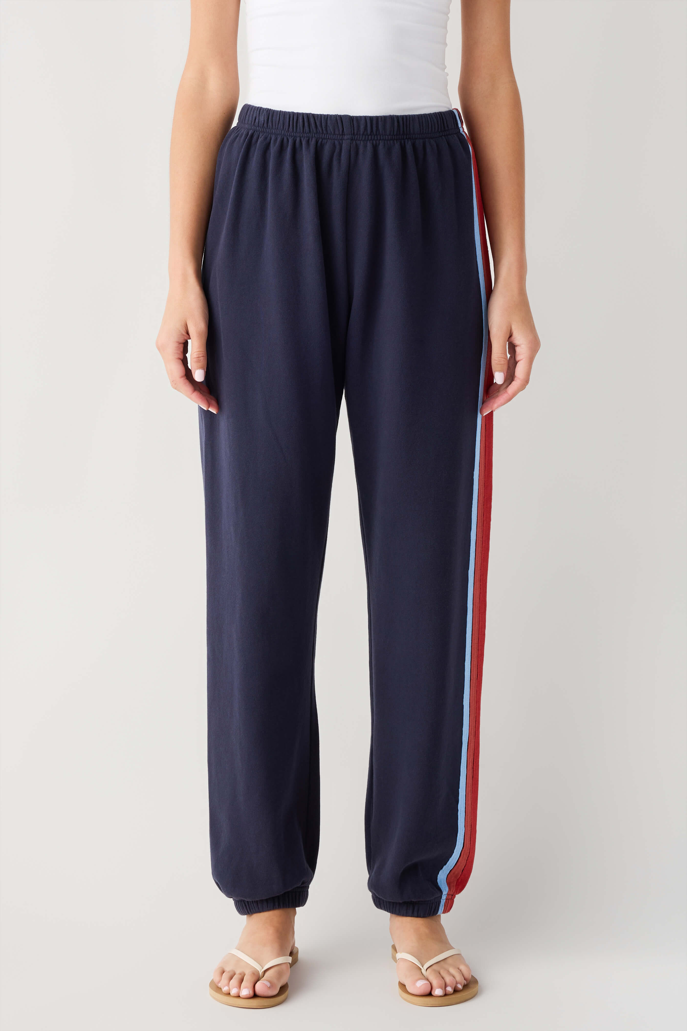 Navy jogger pants with wide red and blue side stripe and elastic waist