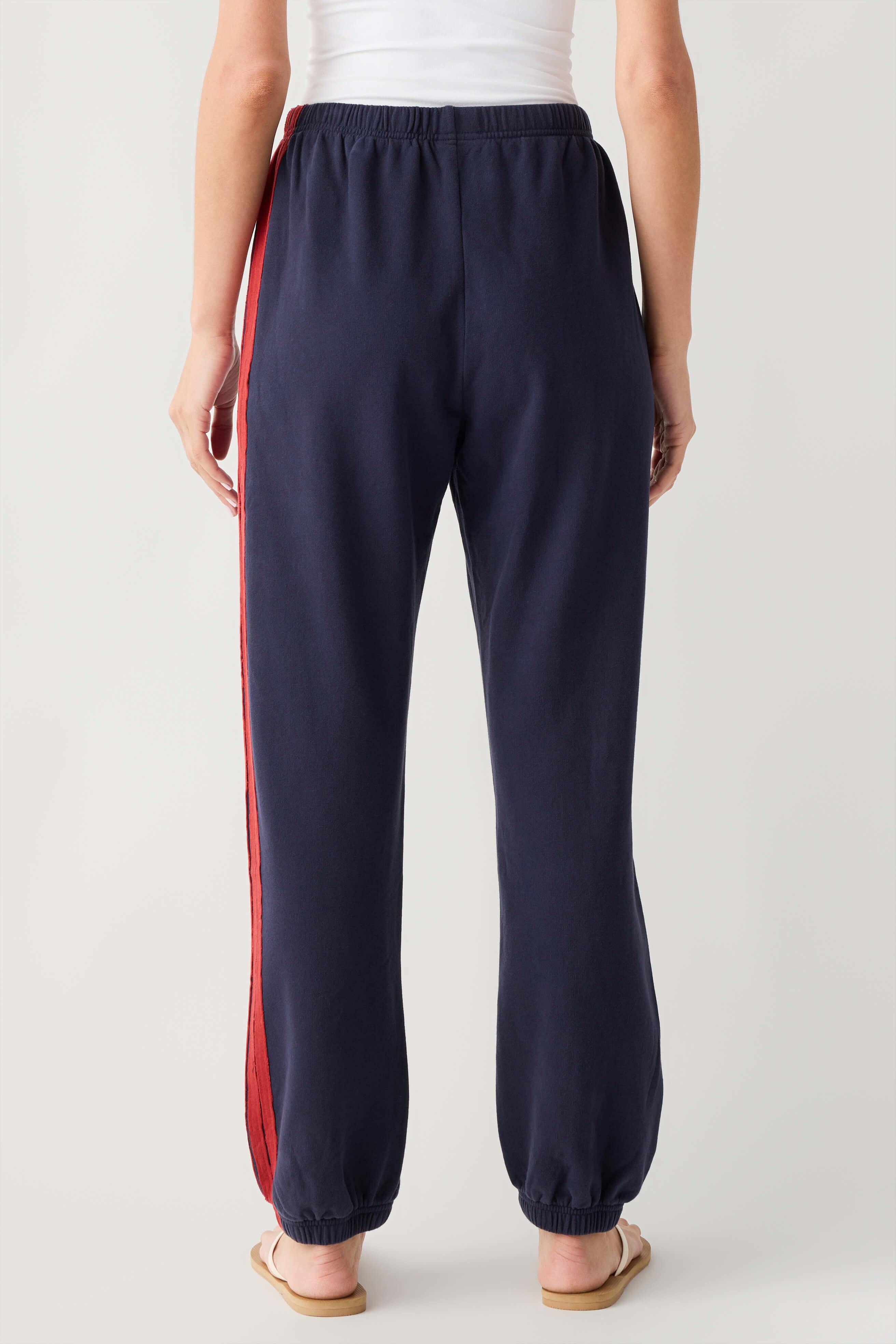 Navy jogger pants with drawstring elastic waist and red side stripe