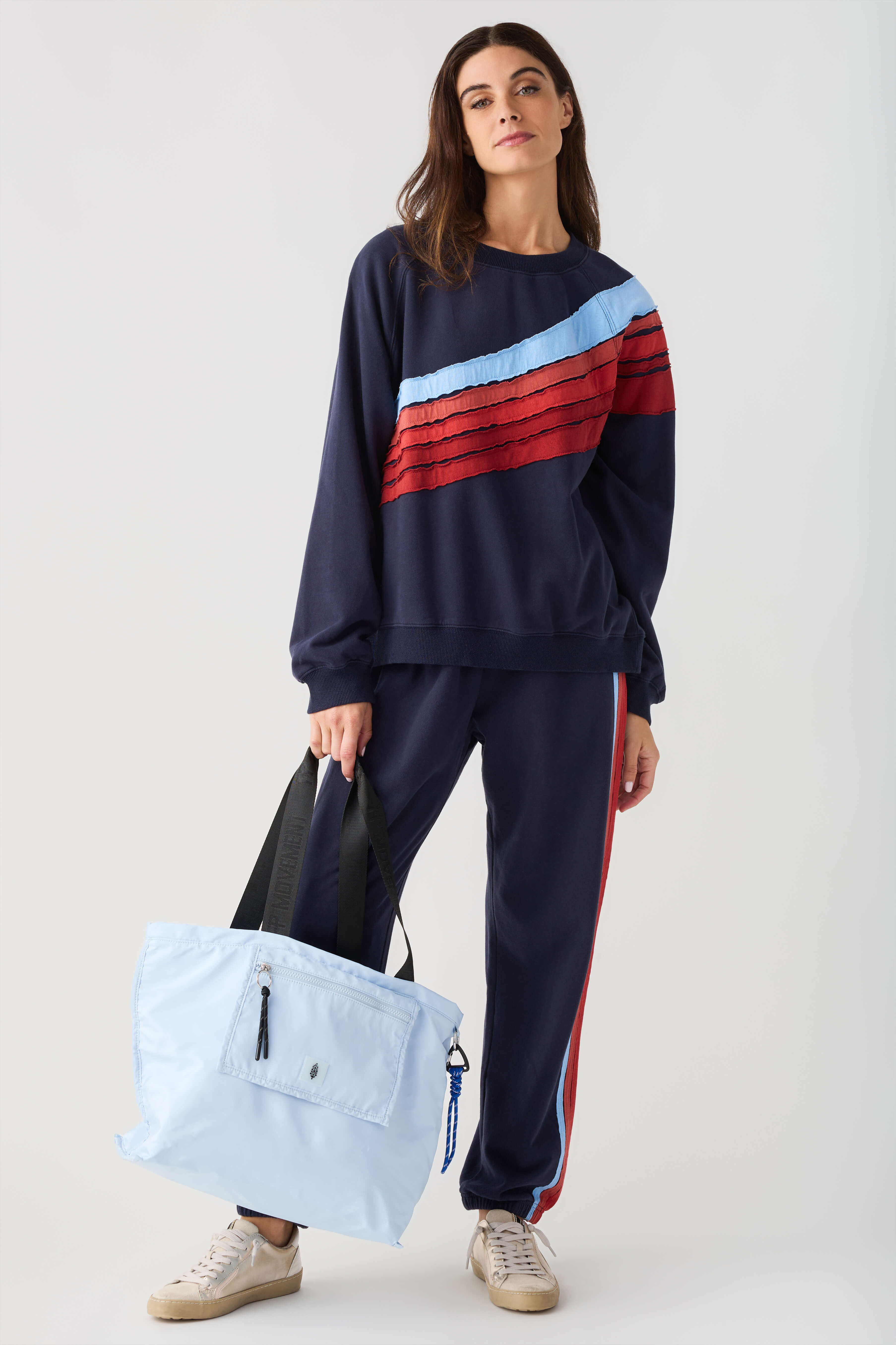 Navy jogger pants with red and white side stripe and elastic cuffs
