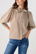 Brown gingham tie-neck blouse featuring a small bow collar and button placket