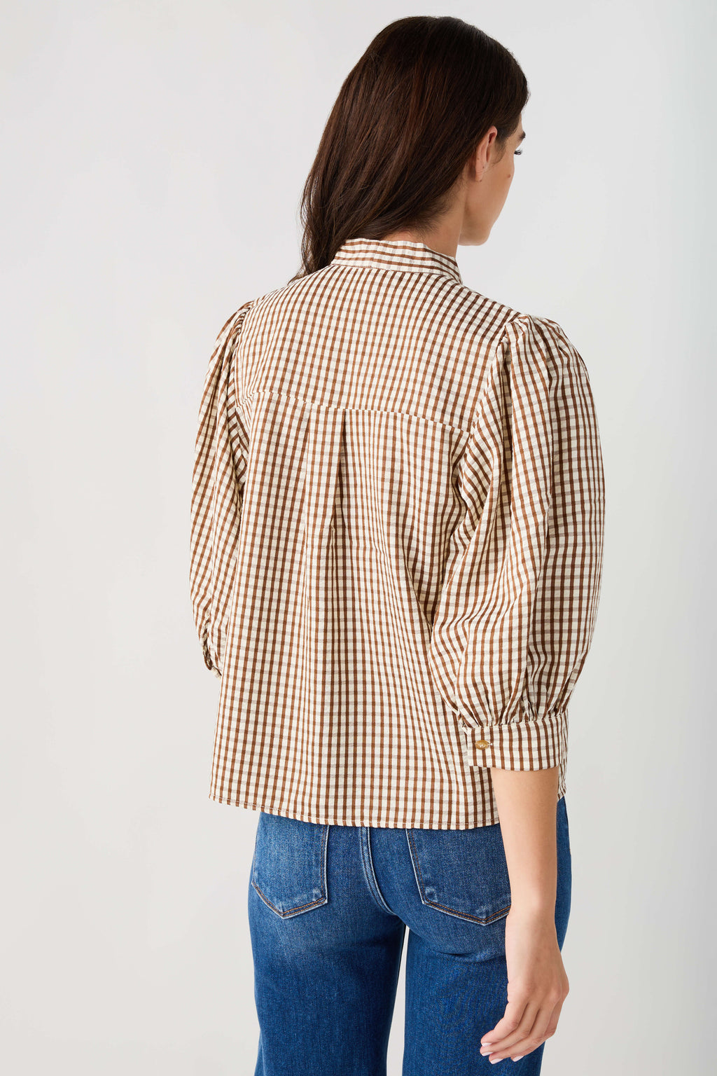 Brown gingham tie-neck blouse back view with gathered sleeves and button detailing