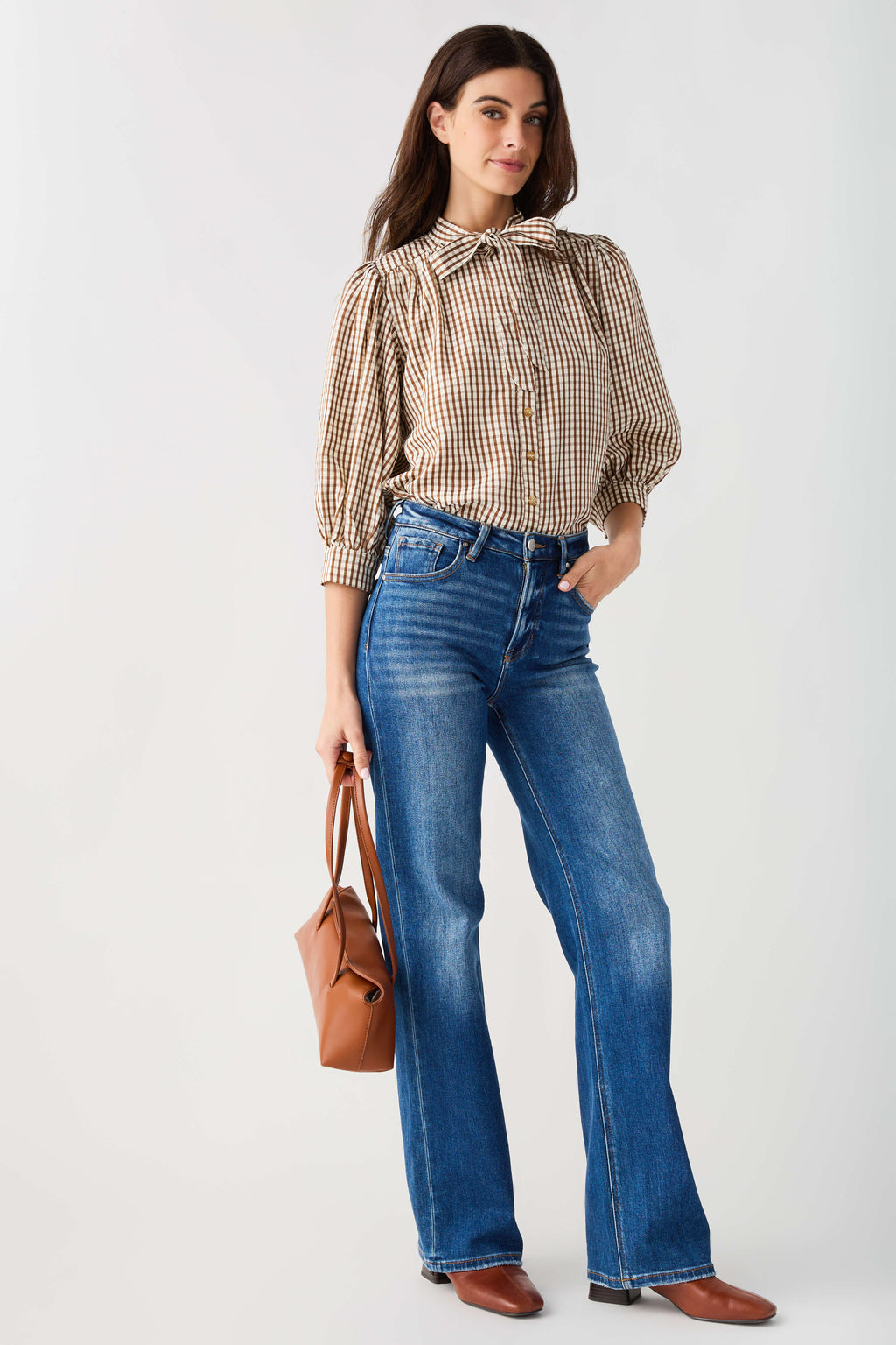Brown gingham tie-neck blouse with gathered puff sleeves and button front