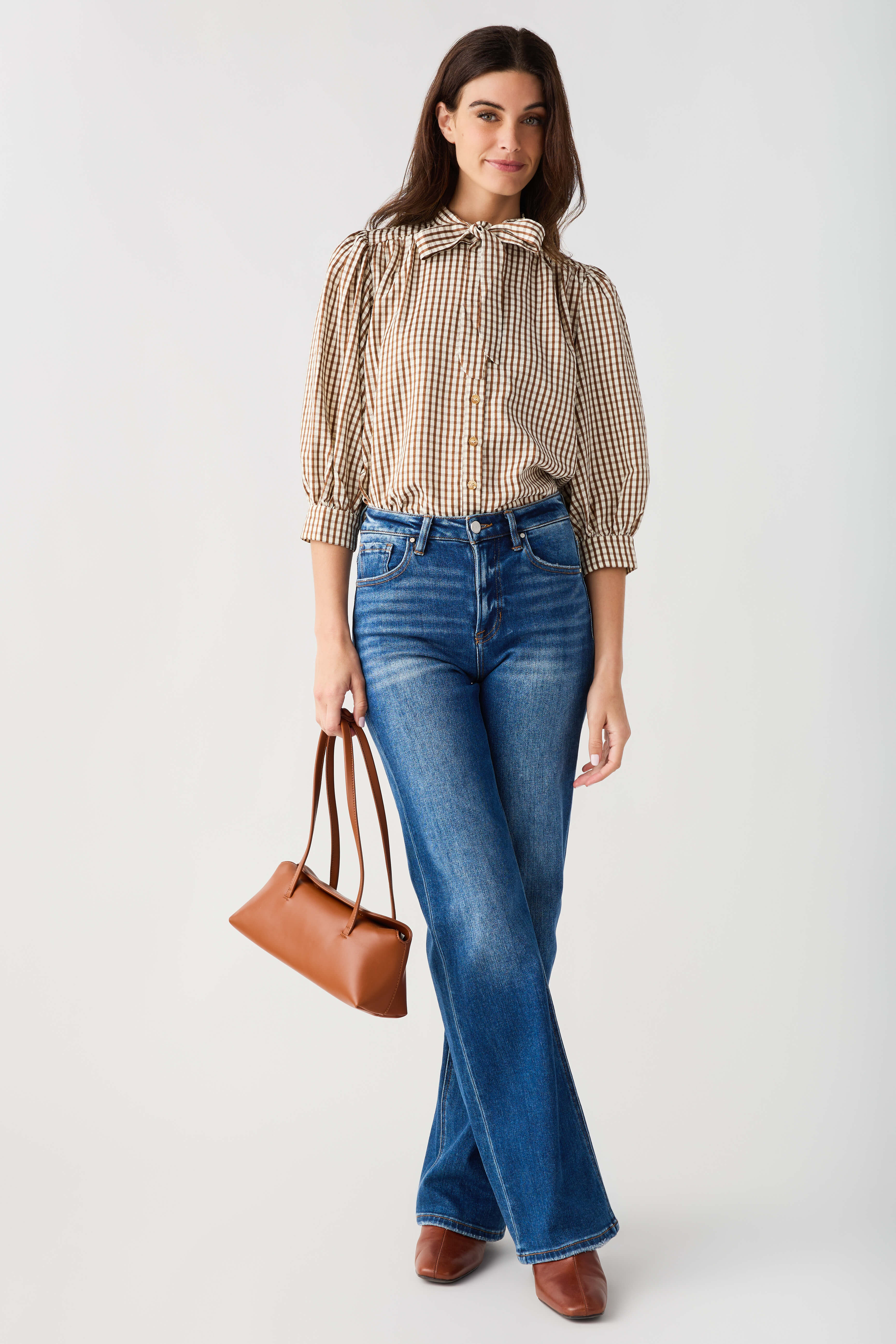 Brown gingham tie-neck blouse with button front and softly gathered sleeves