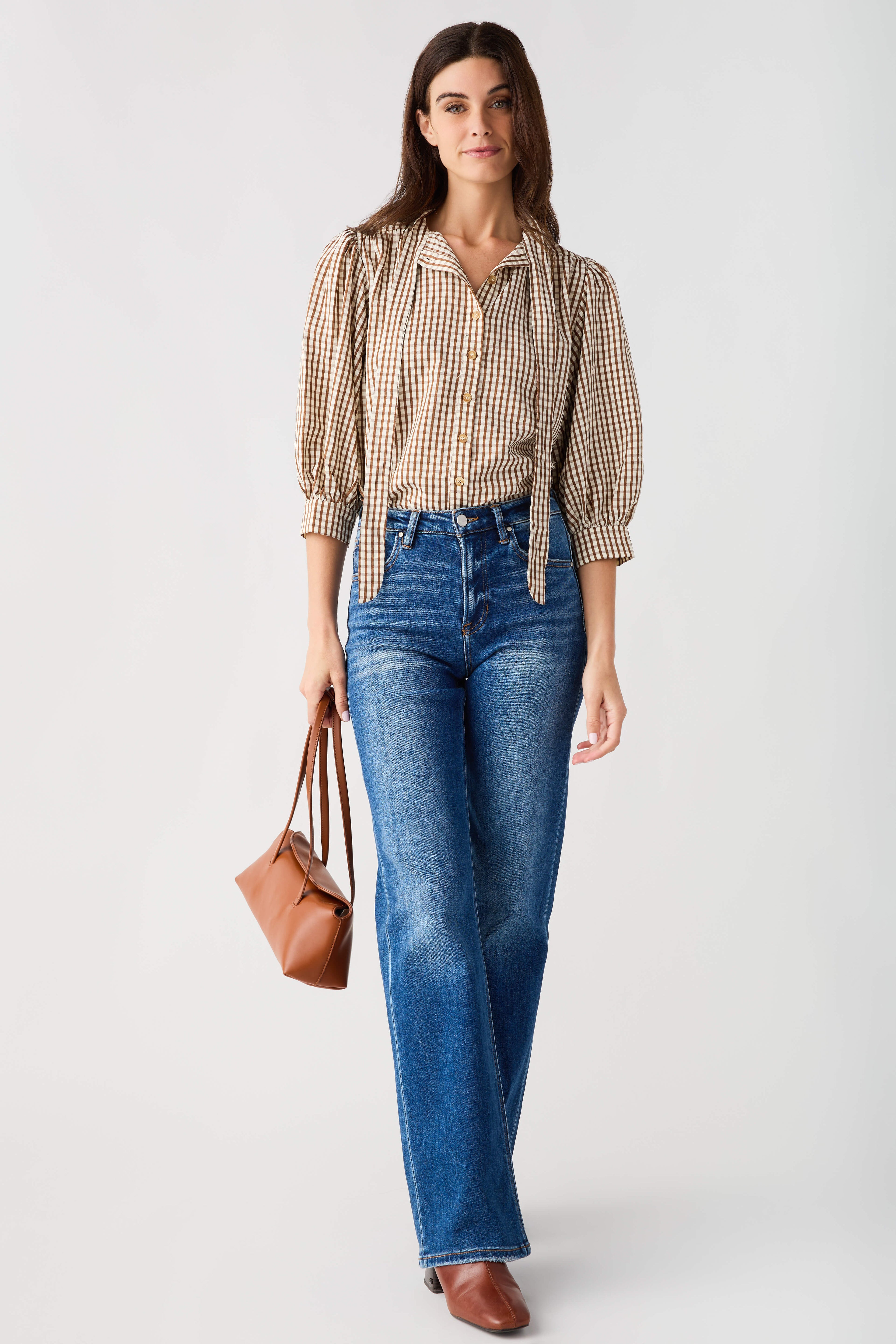 Brown gingham tie-neck blouse with ruffled collar and quarter puff sleeves