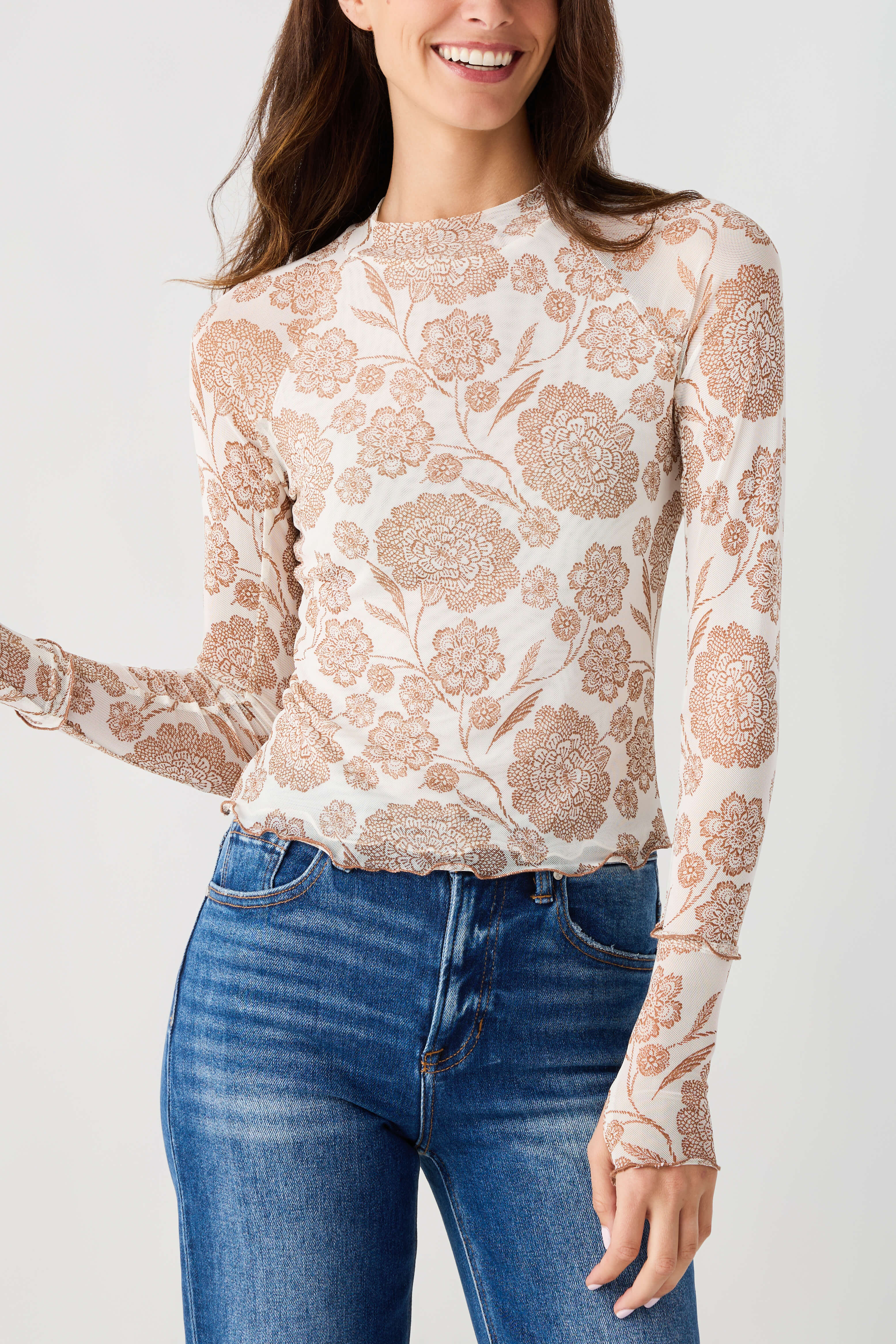 Cream floral mesh mock neck top with long sleeves, sheer textured fabric.