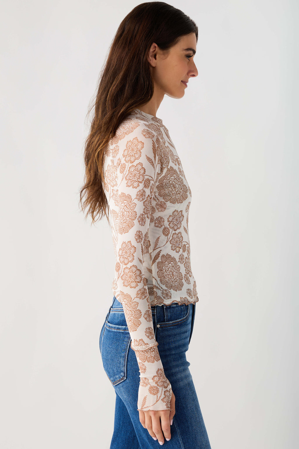Cream floral mesh mock neck top in side view, long sheer sleeves with print.