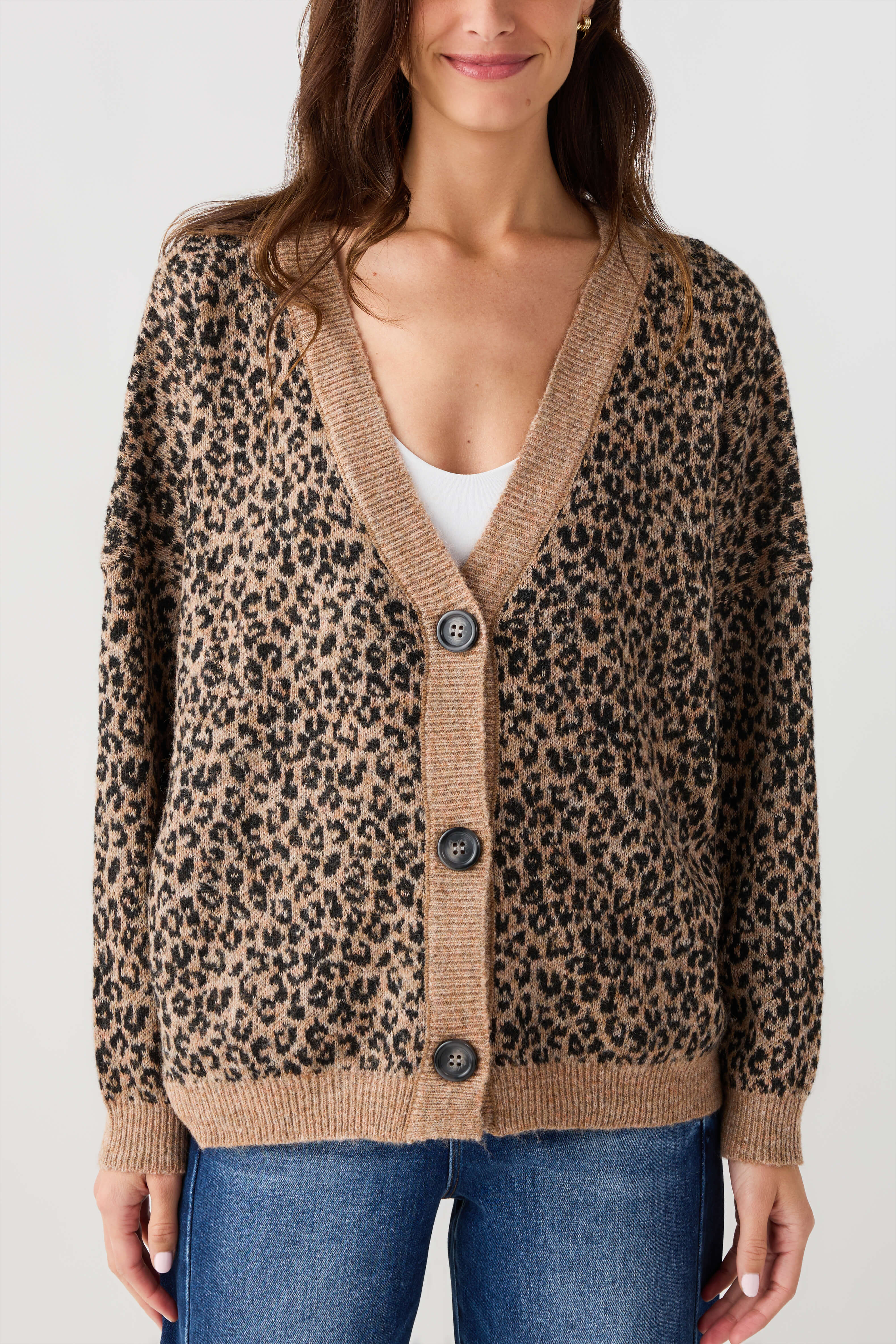Leopard print cardigan sweater detail: button placket, V neckline, ribbed hem