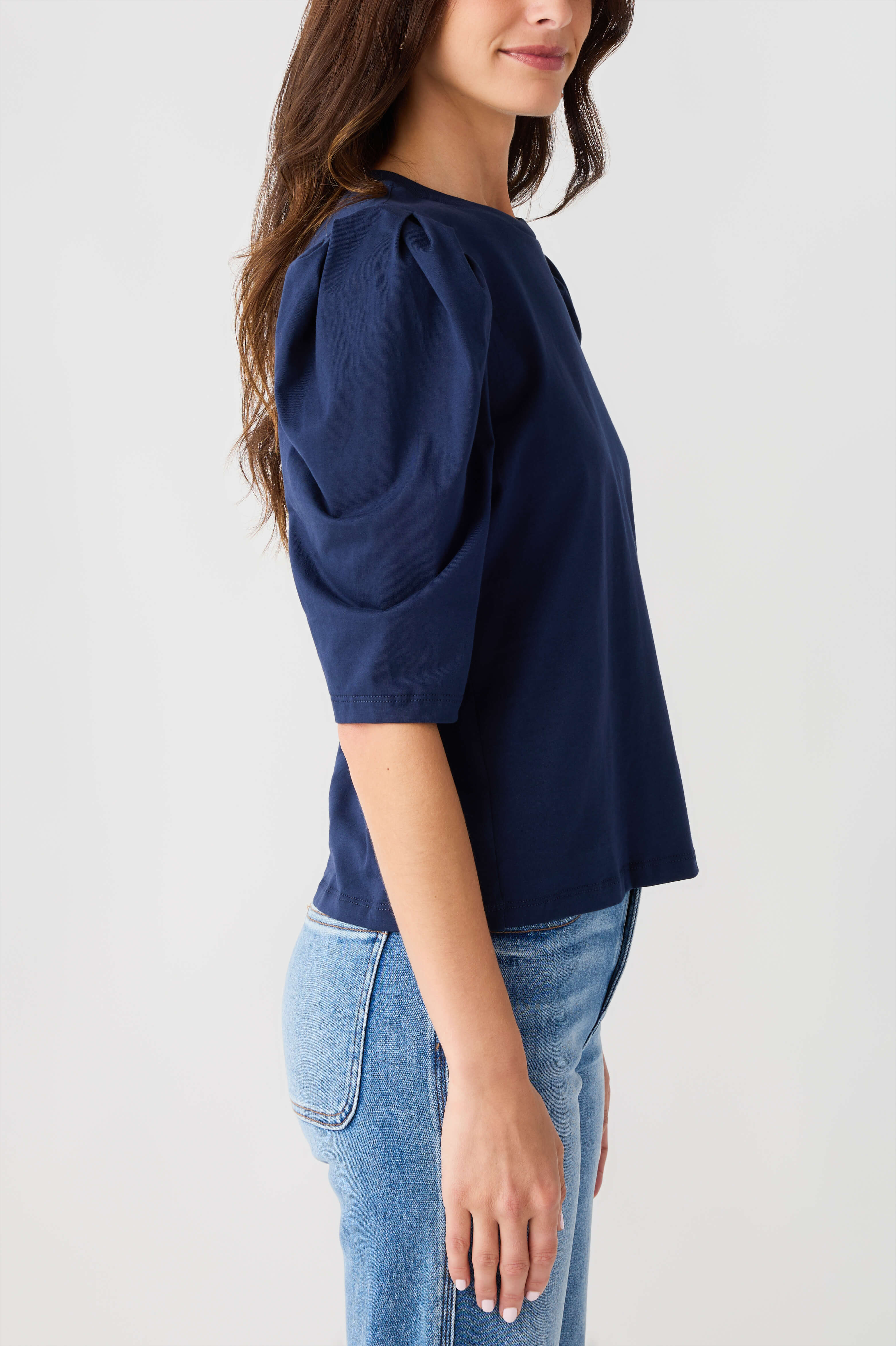 Navy puff-sleeve jersey top with crew neck; gathered sleeves and side profile