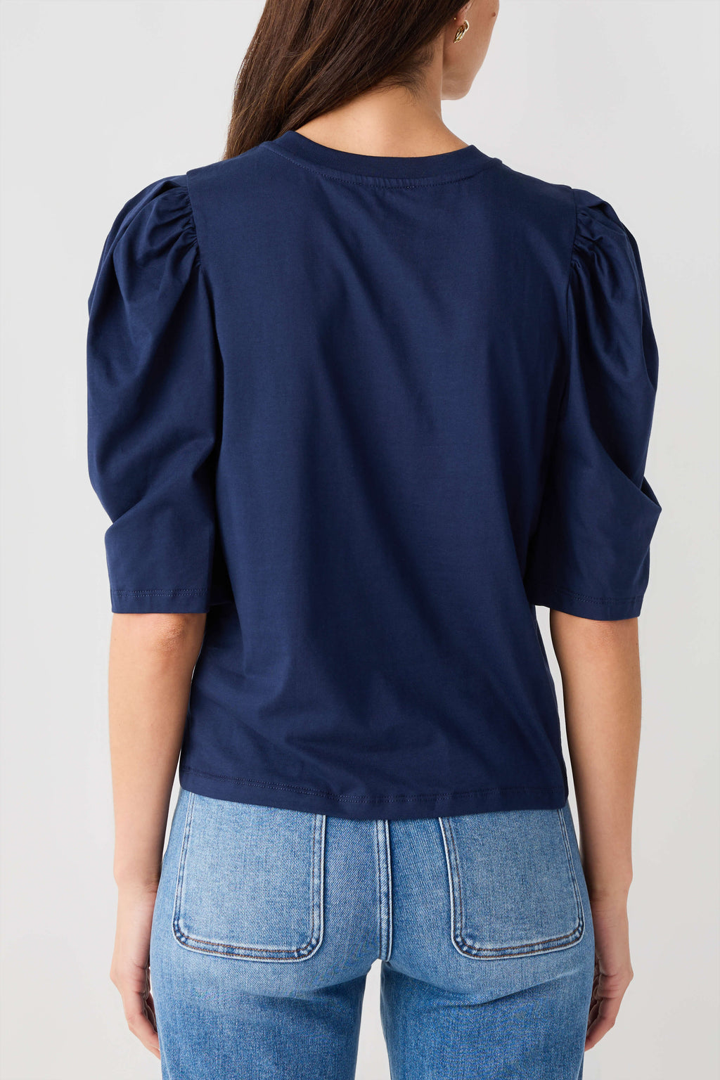 Navy puff-sleeve jersey top with gathered shoulders and smooth back yoke