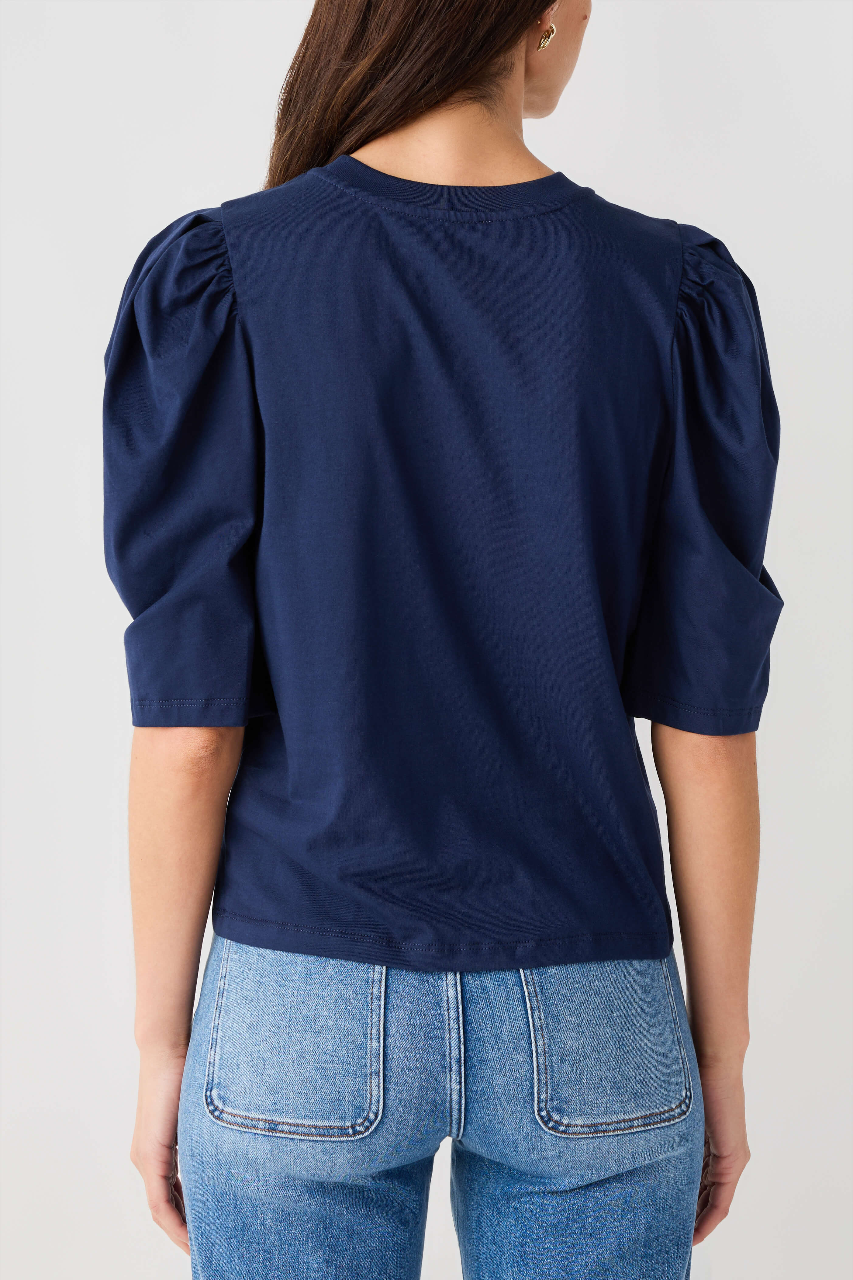 Navy puff-sleeve jersey top with gathered shoulders and smooth back yoke