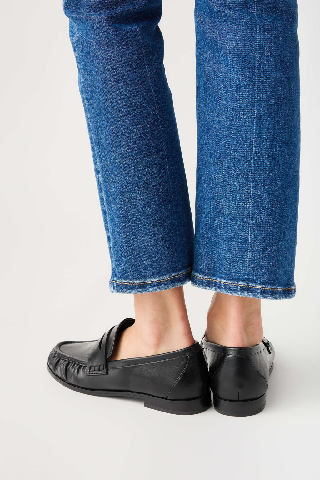 Black leather loafer rear view with side strap and textured heel