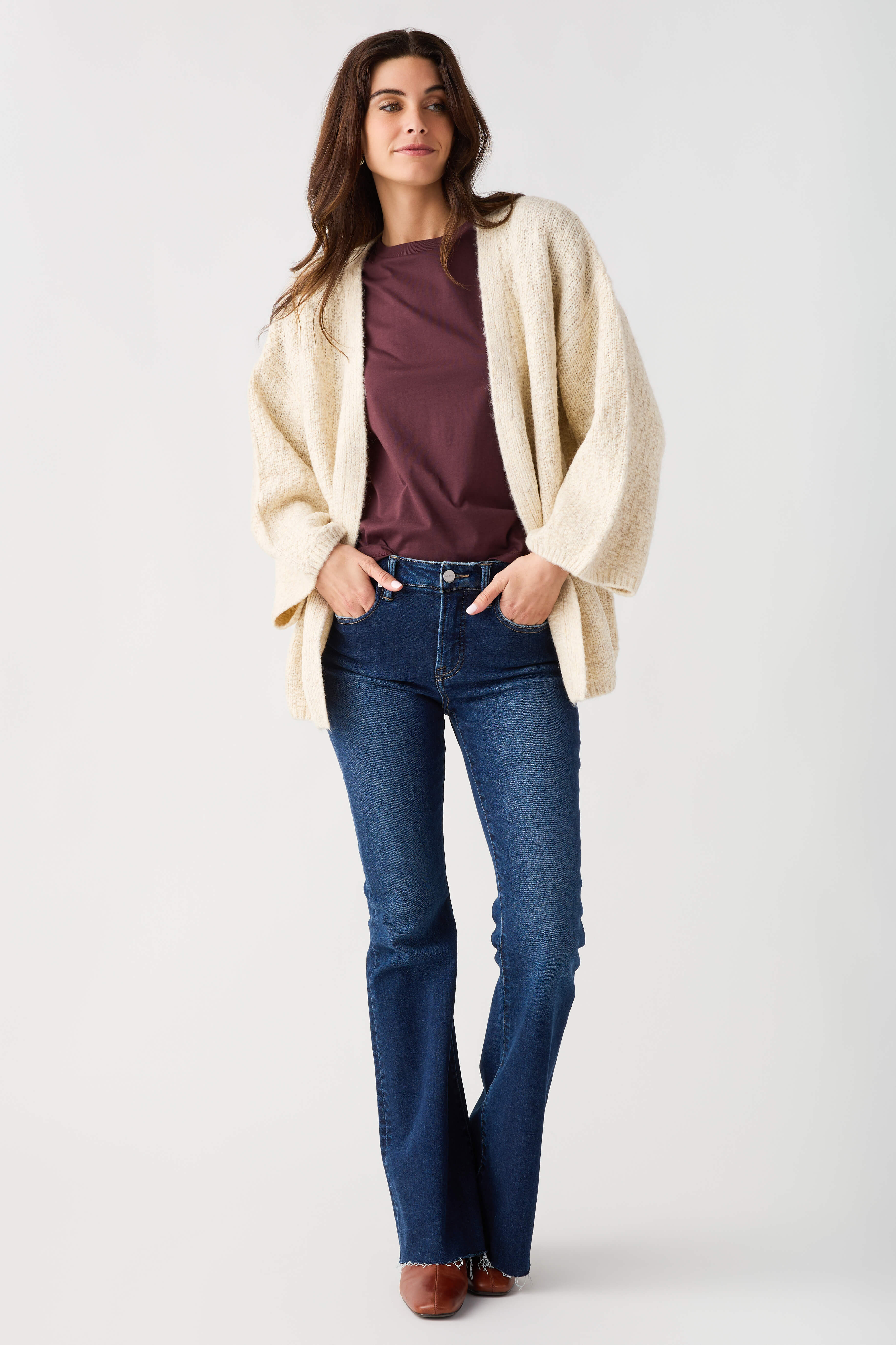 Light beige textured knit open-front cardigan with long sleeves and draped hem