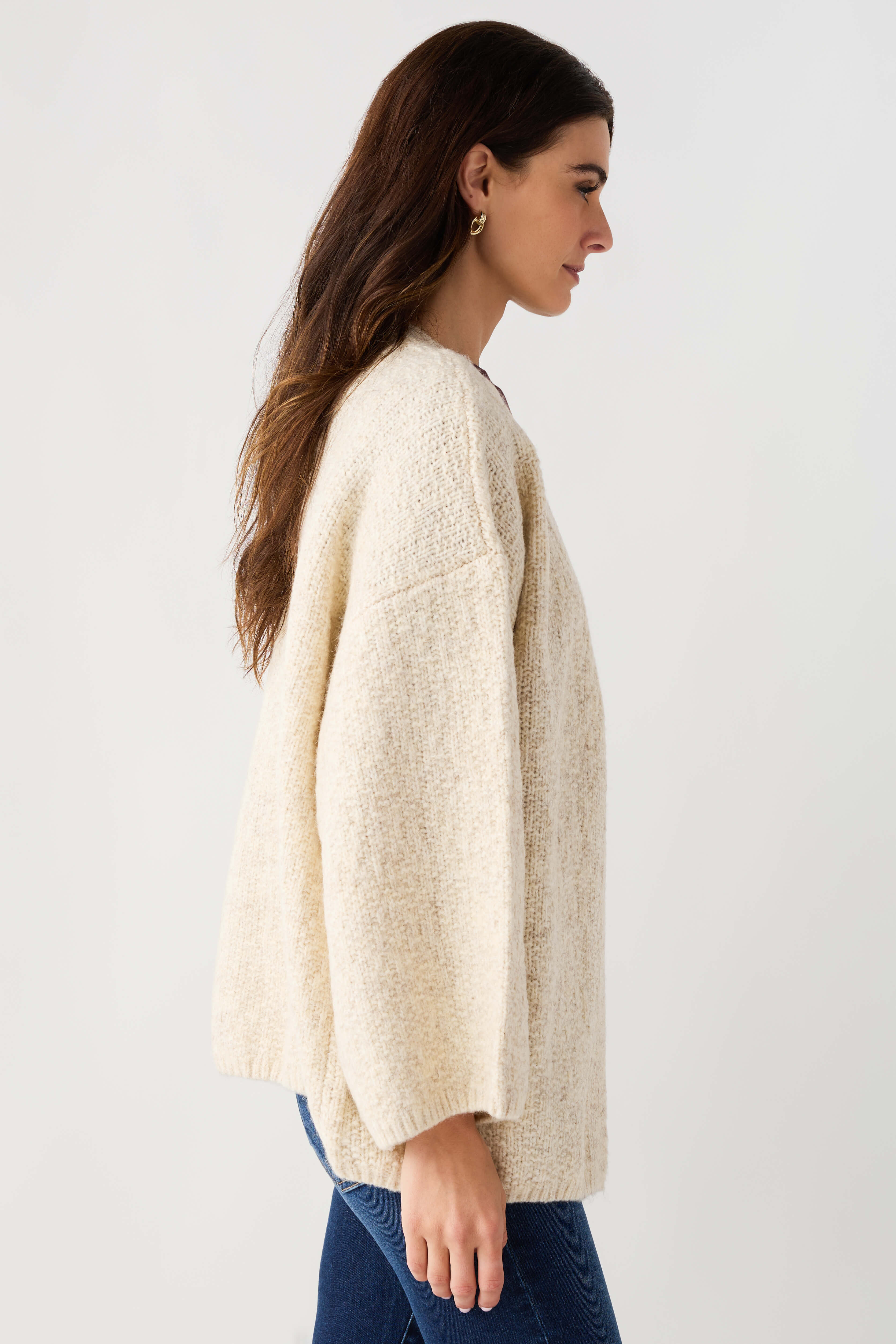Light beige open-front cardigan with textured knit and long sleeves, side view