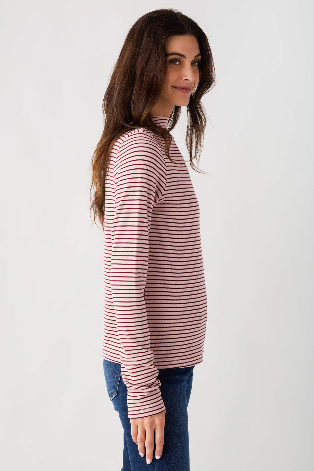 Mauve-and-white striped mockneck knit top with long sleeves, side profile