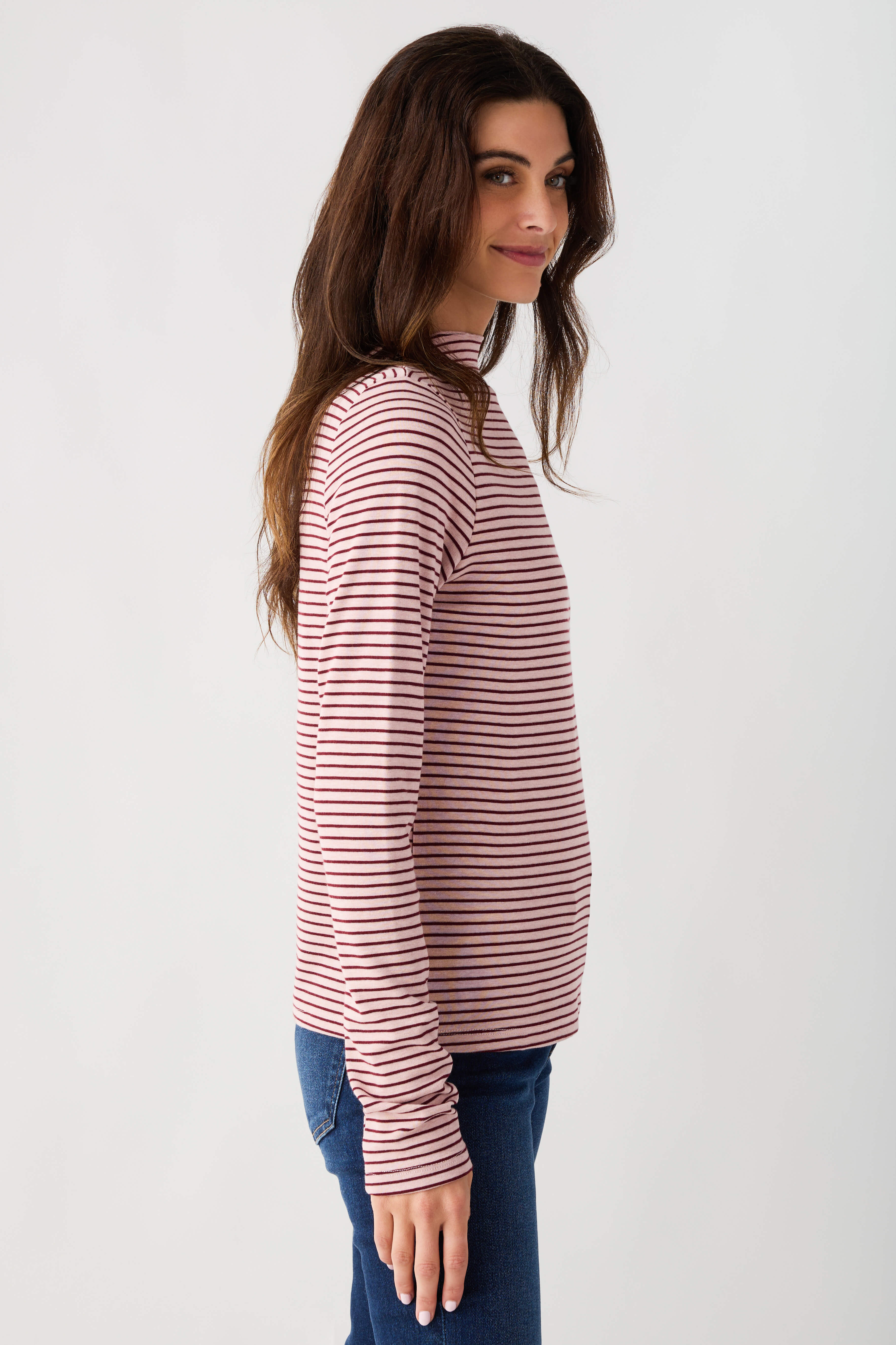 Mauve-and-white striped mockneck knit top with long sleeves, side profile