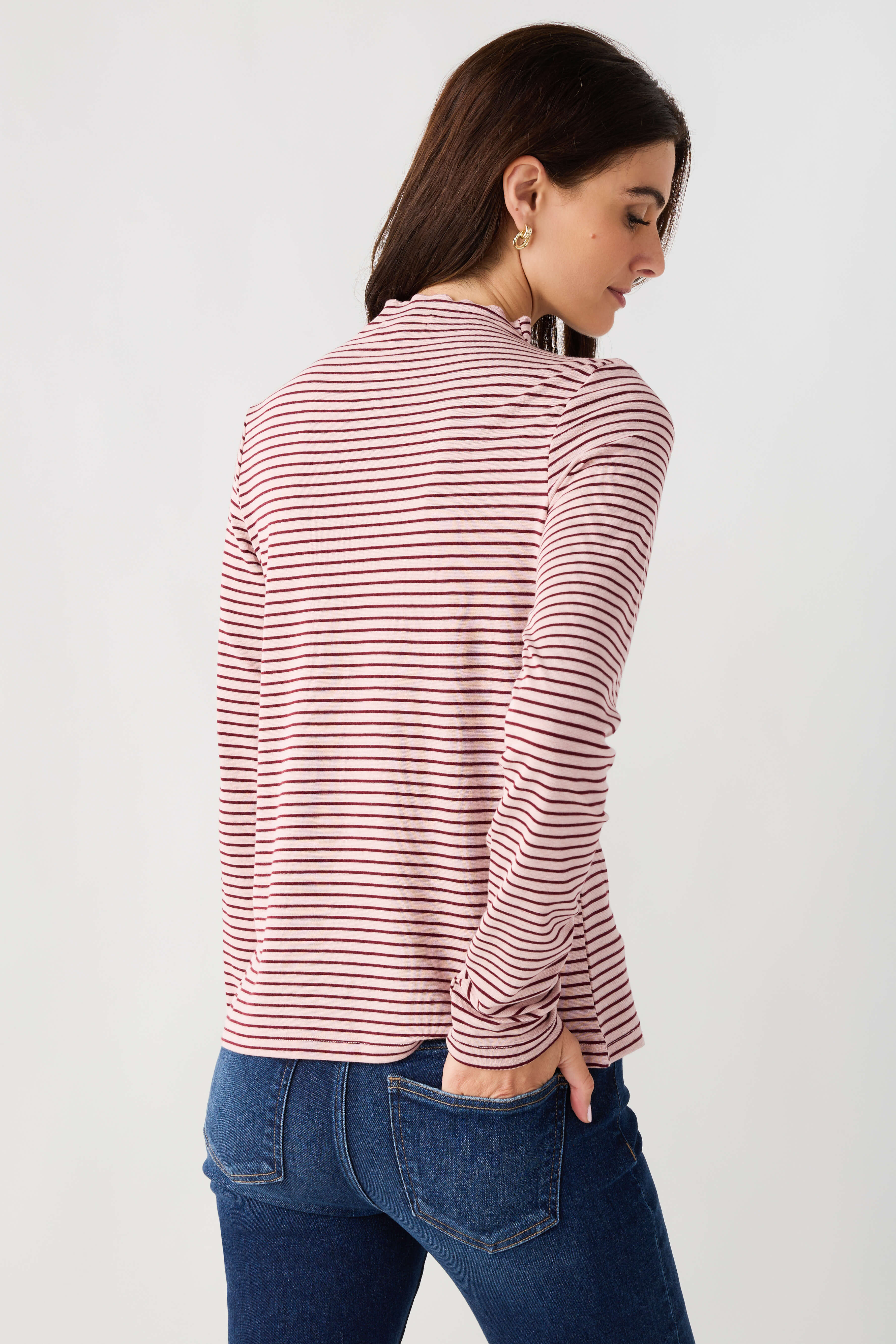 Mauve-and-white striped mockneck knit top with long sleeves, back view