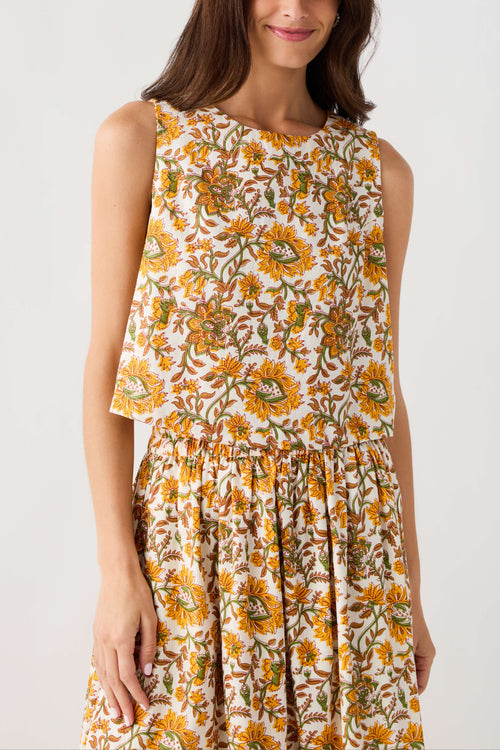 Floral print sleeveless top with round neckline, button front, and gathered peplum hem