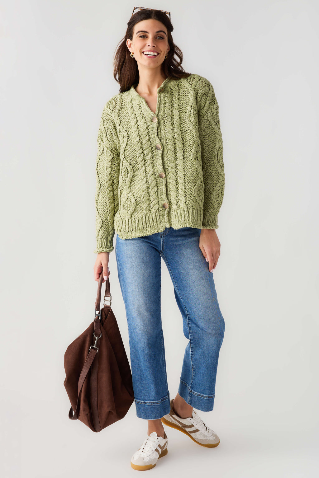 Green cable-knit cardigan with button front and long sleeves