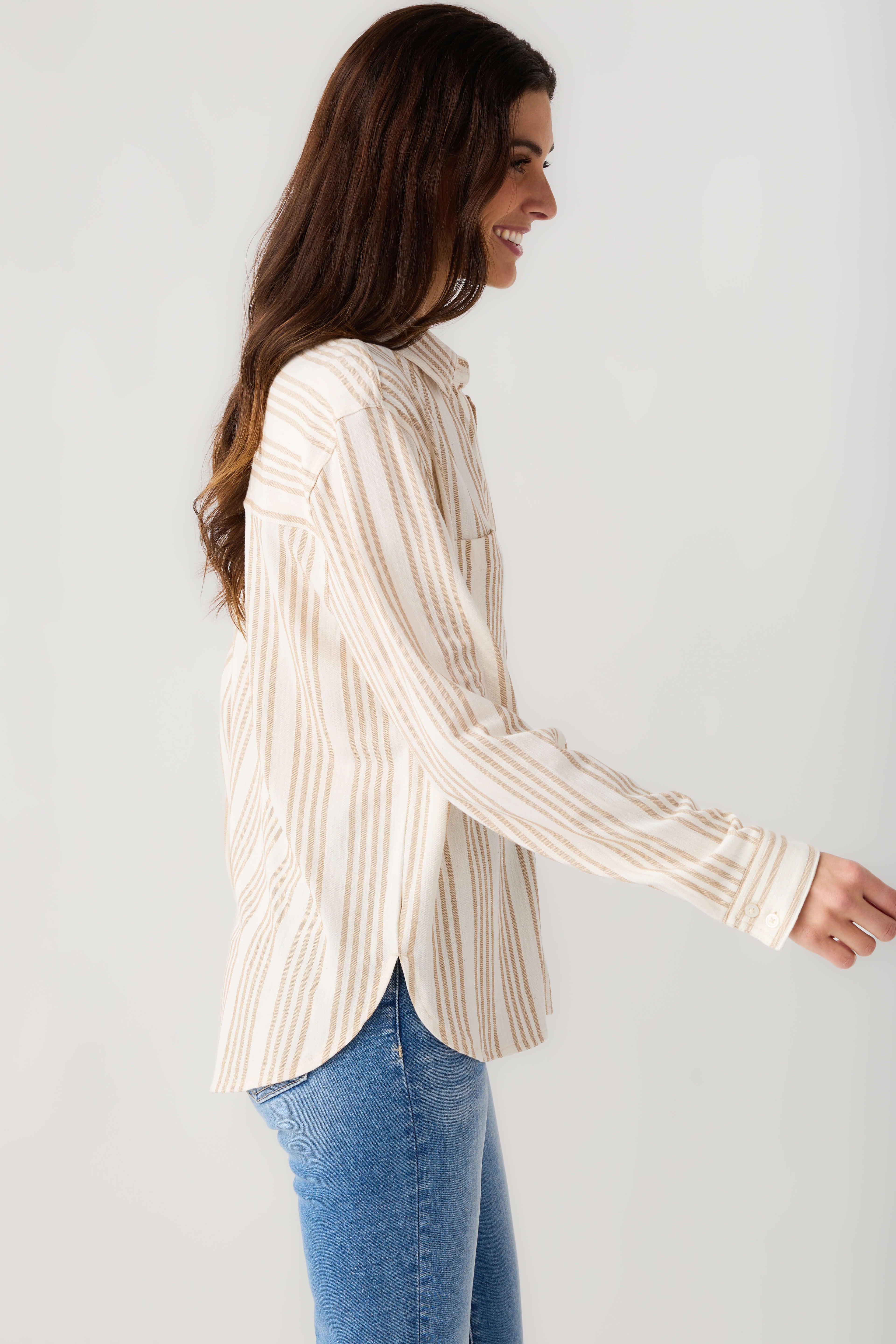 Cream and tan striped button-up shirt, long sleeves and front buttons, side view