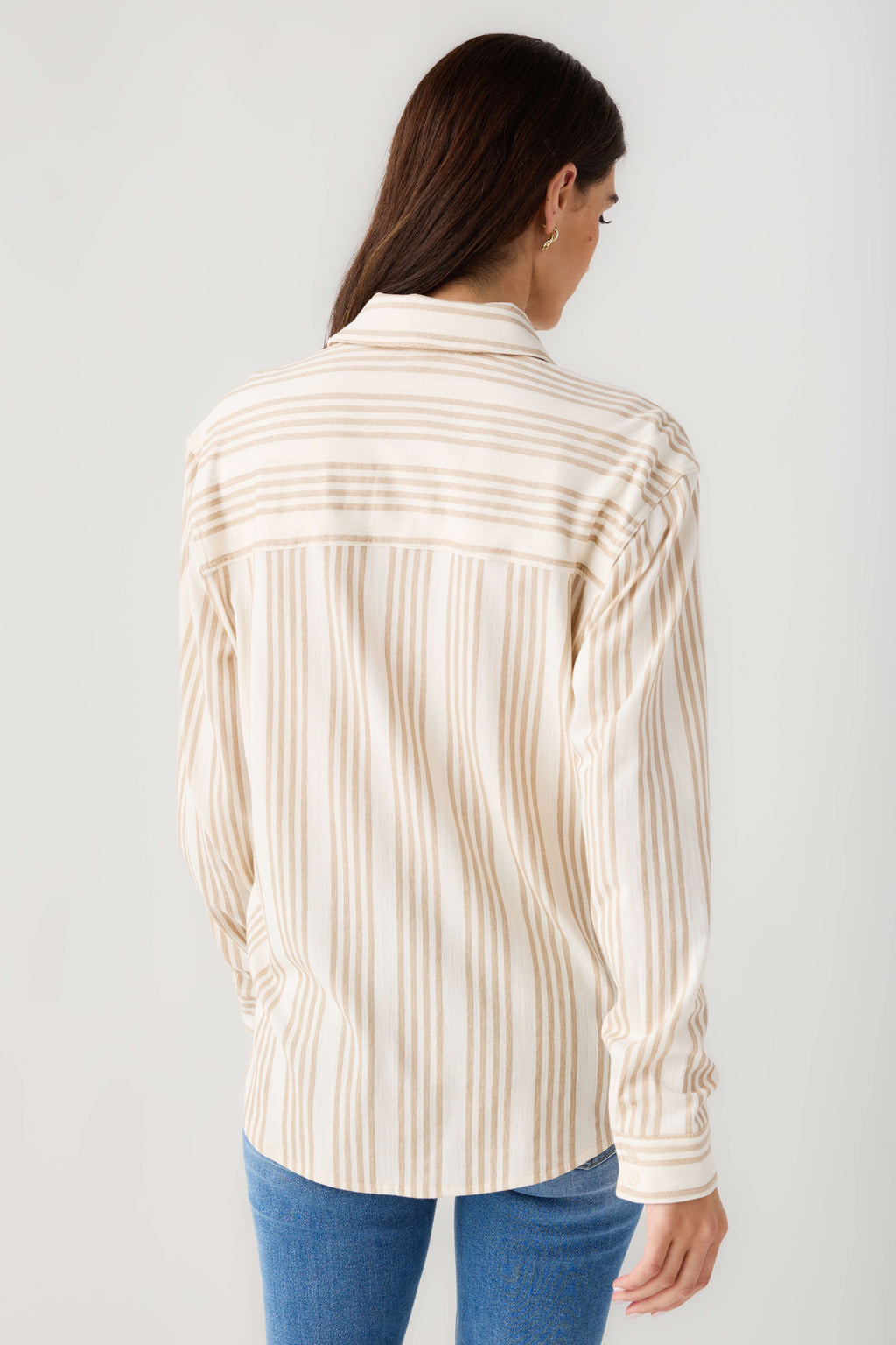 Cream and tan striped button-up shirt with long sleeves and collar, back view