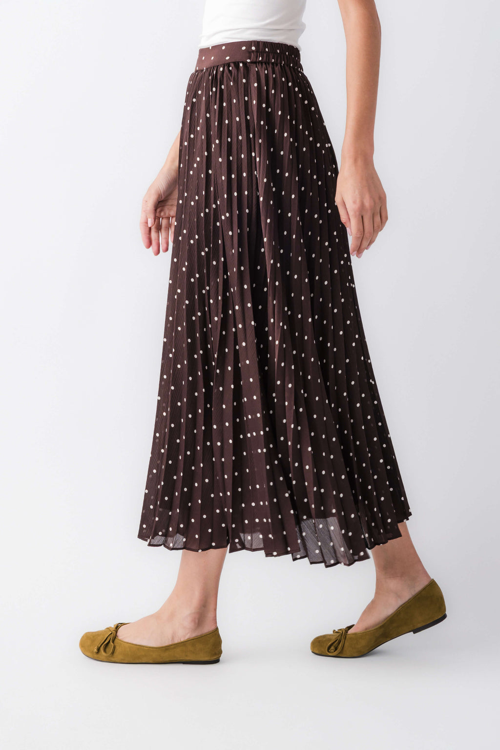 Brown sheer pleated maxi skirt with tiny white dot pattern and elastic waist