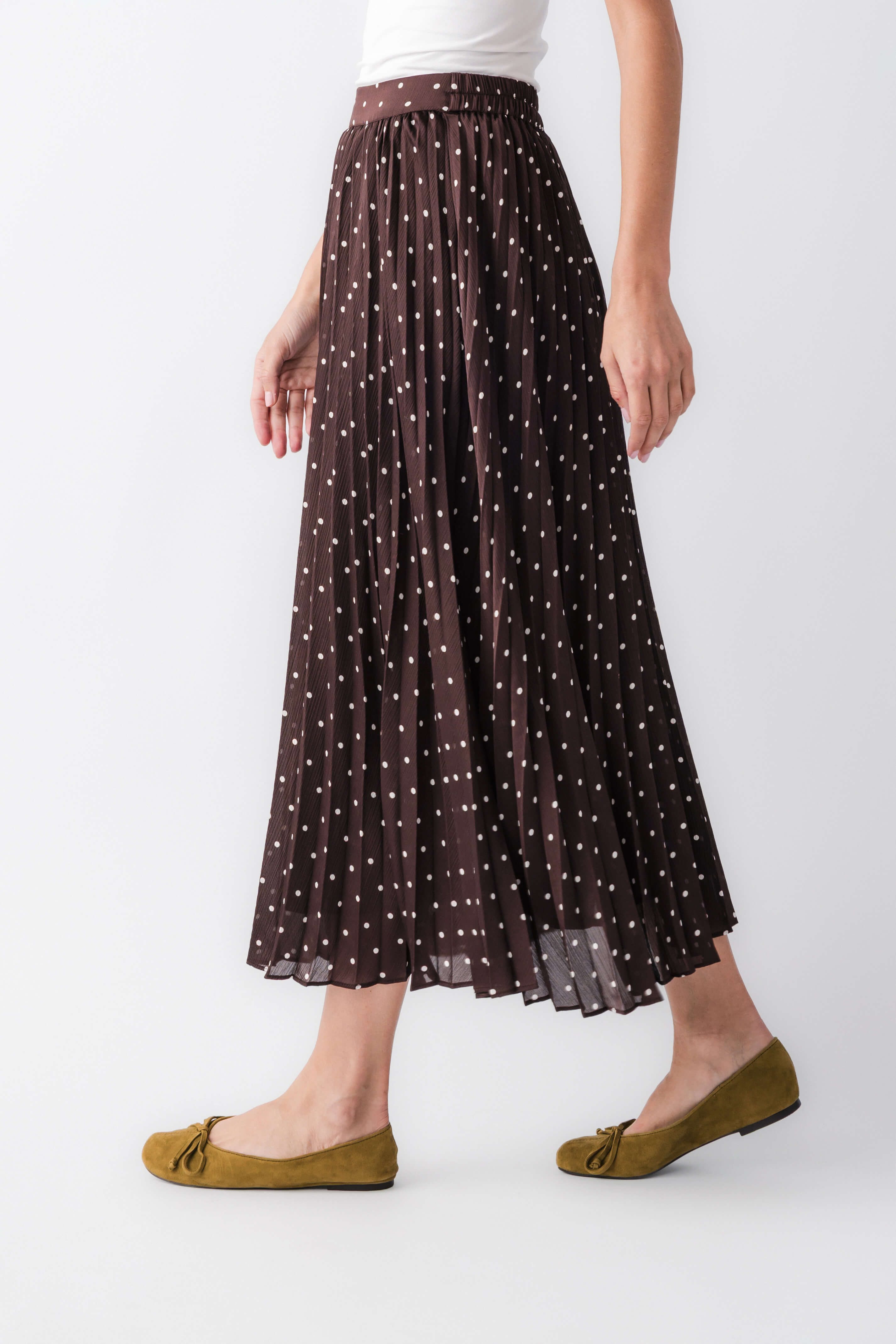 Brown sheer pleated maxi skirt with tiny white dot pattern and elastic waist