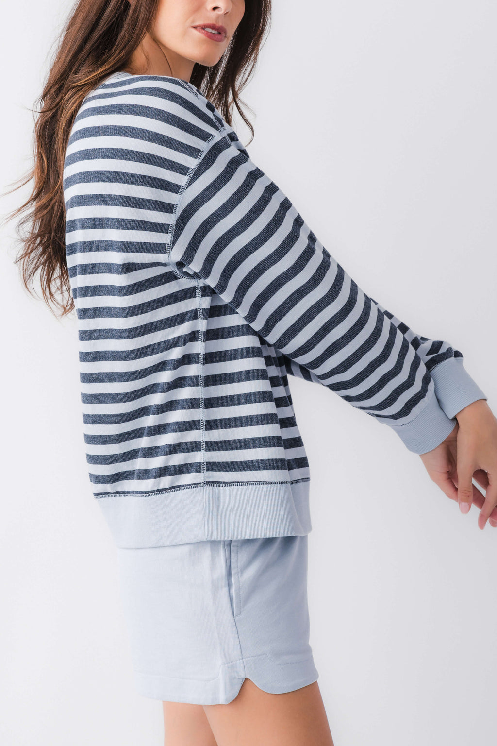 Women’s striped crewneck sweatshirt in navy and white, side view with ribbed cuffs